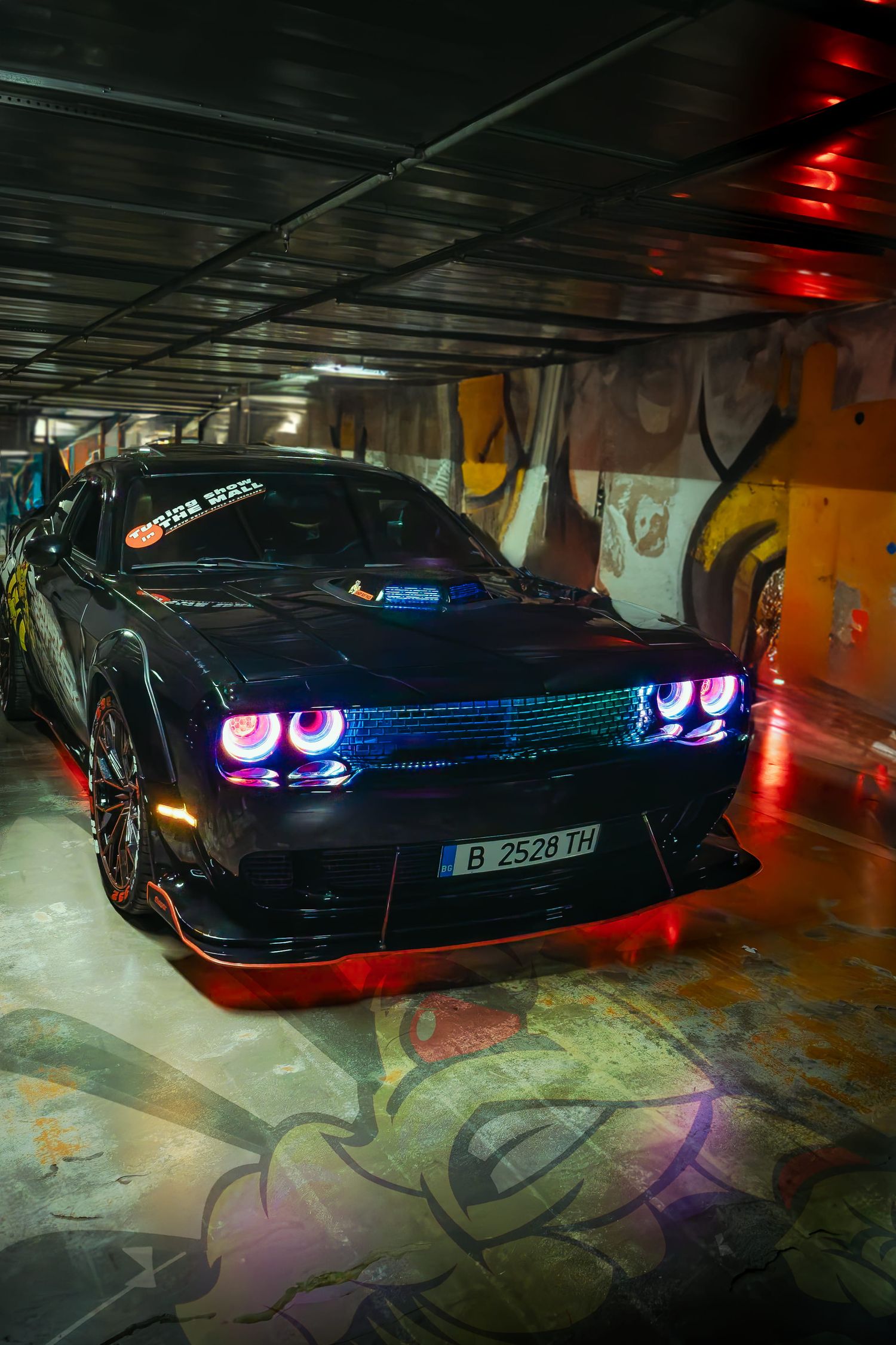 Black Dodge muscle car with neon lighting in underground garage – automotive photography in Bulgaria.