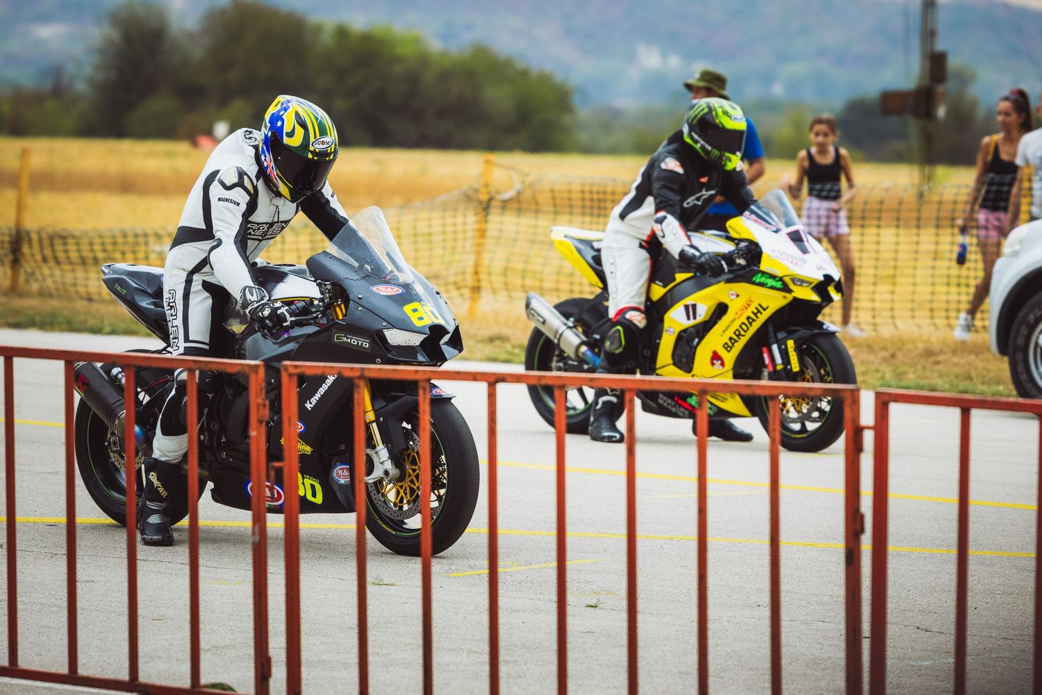 Motorcycle riders preparing at starting line before race – motorsport photography in Bulgaria.