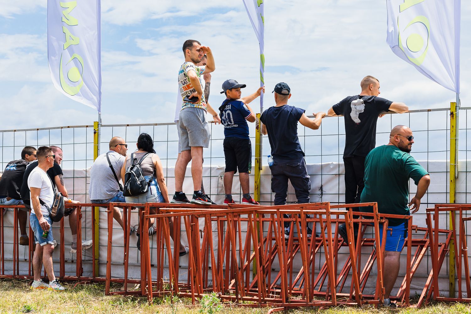 Spectators positioned behind barriers, documenting event atmosphere and public engagement in Bulgaria.