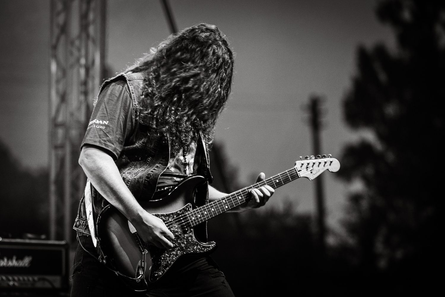 Black and white live performance shot capturing raw intensity and focus during a guitar solo in Bulgaria.