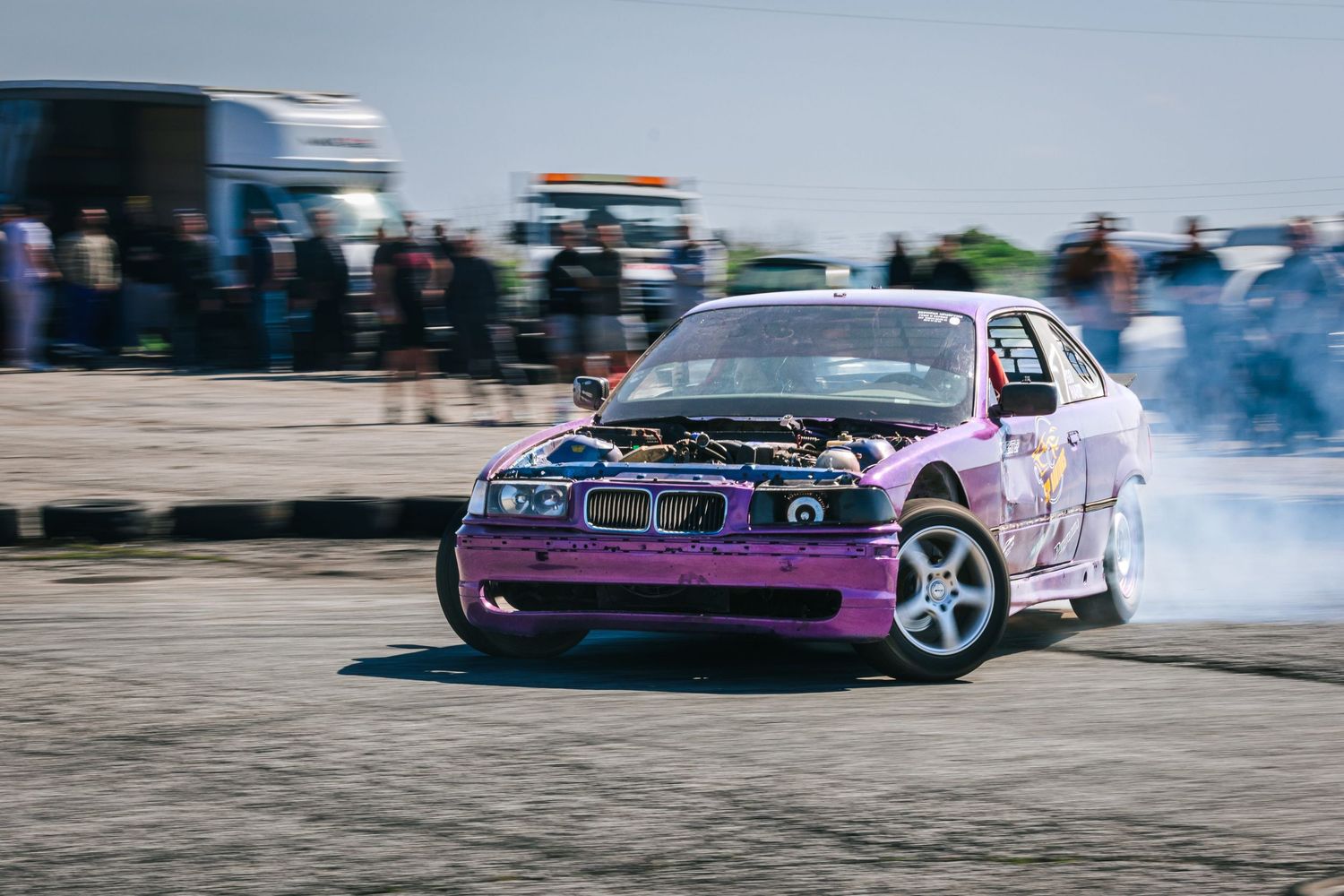 Purple BMW drifting in front of spectators during motorsport event – sports photography in Bulgaria.