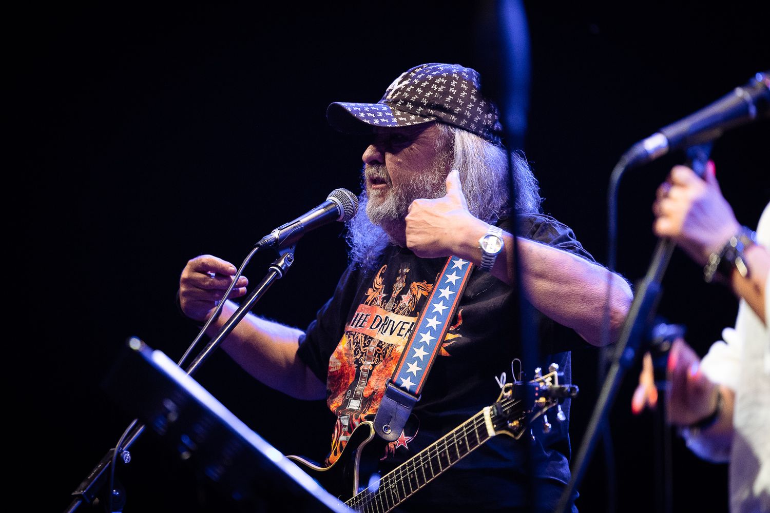 Guitarist performing under stage lights, emphasizing expression, movement and live sound energy in Bulgaria.