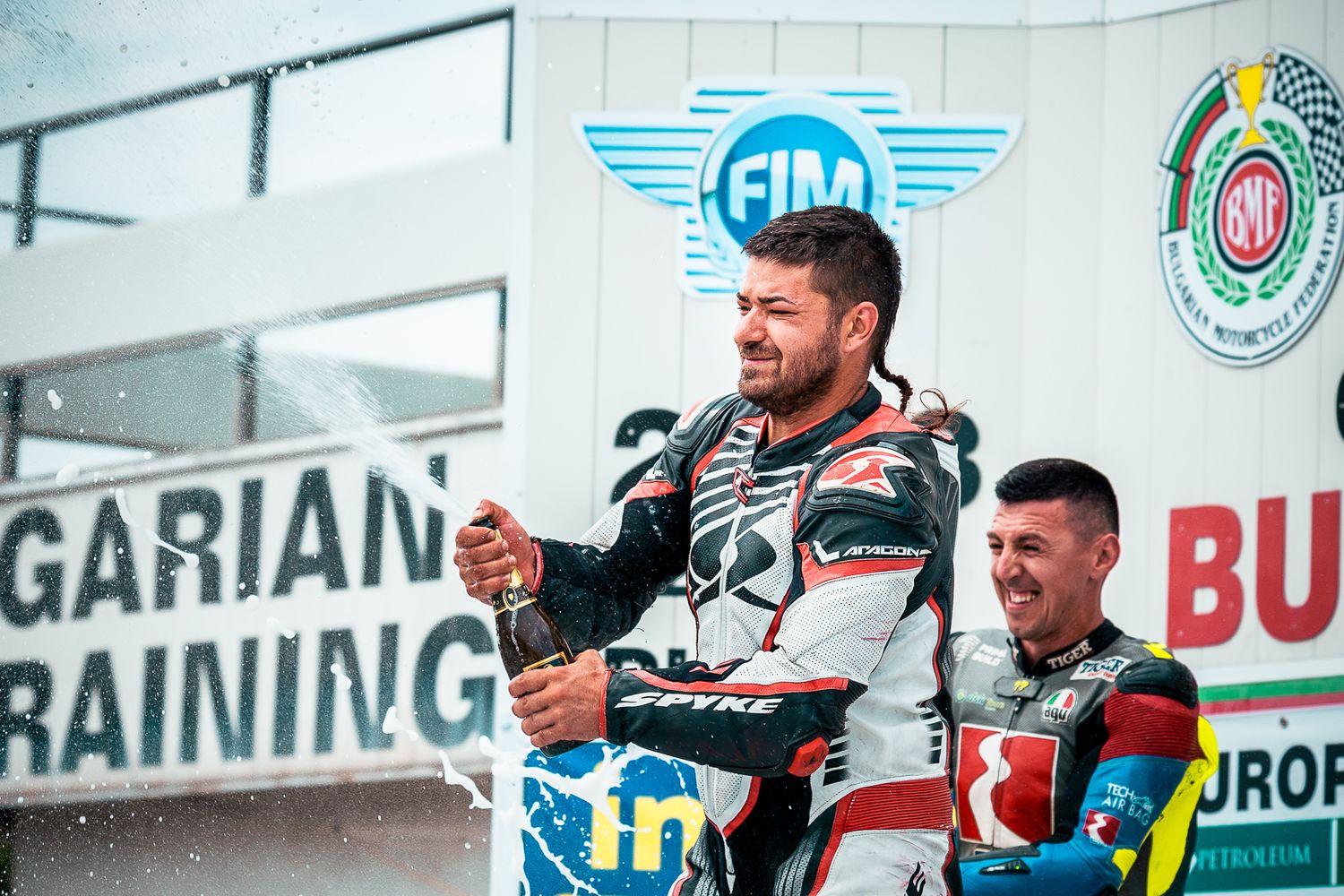 Podium champagne celebration during official ceremony, documenting the peak moment of the event in Bulgaria.