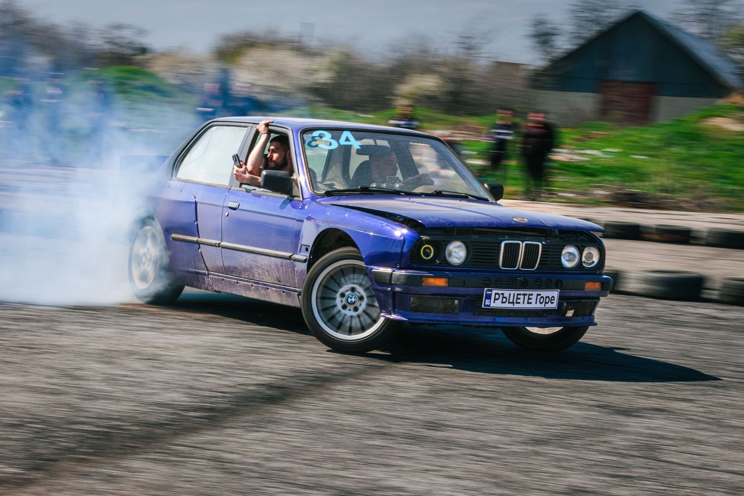 Purple BMW drifting with heavy tire smoke on track – motorsport photography in Bulgaria.