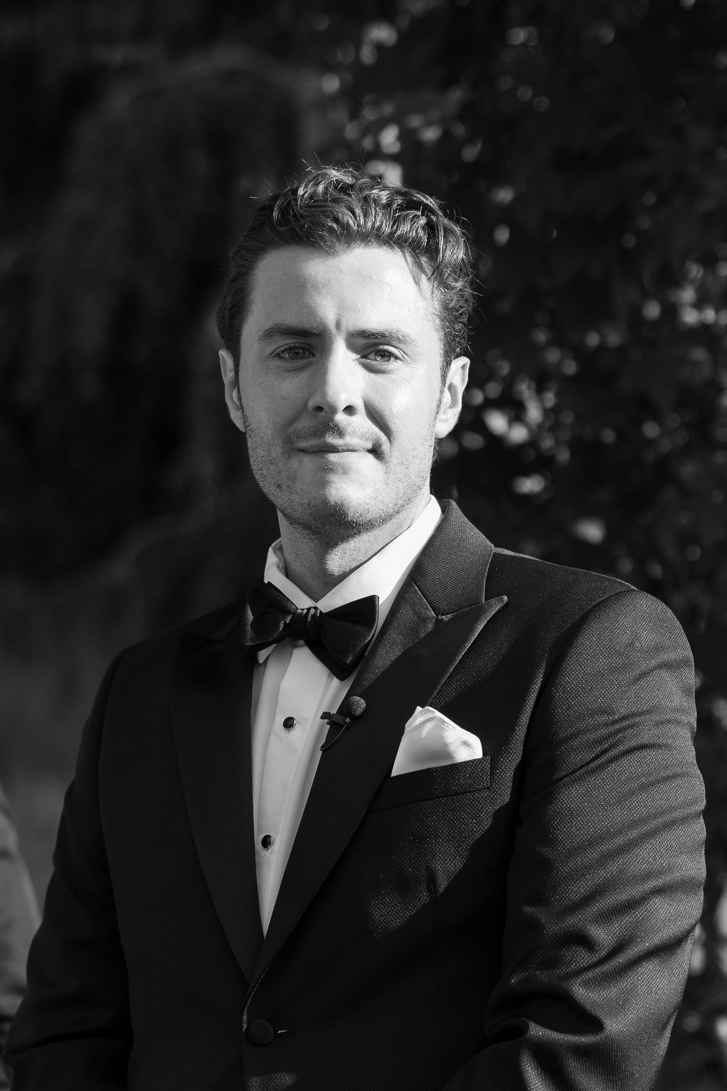 Classic black and white portrait of a person in formal attire with a bow tie.