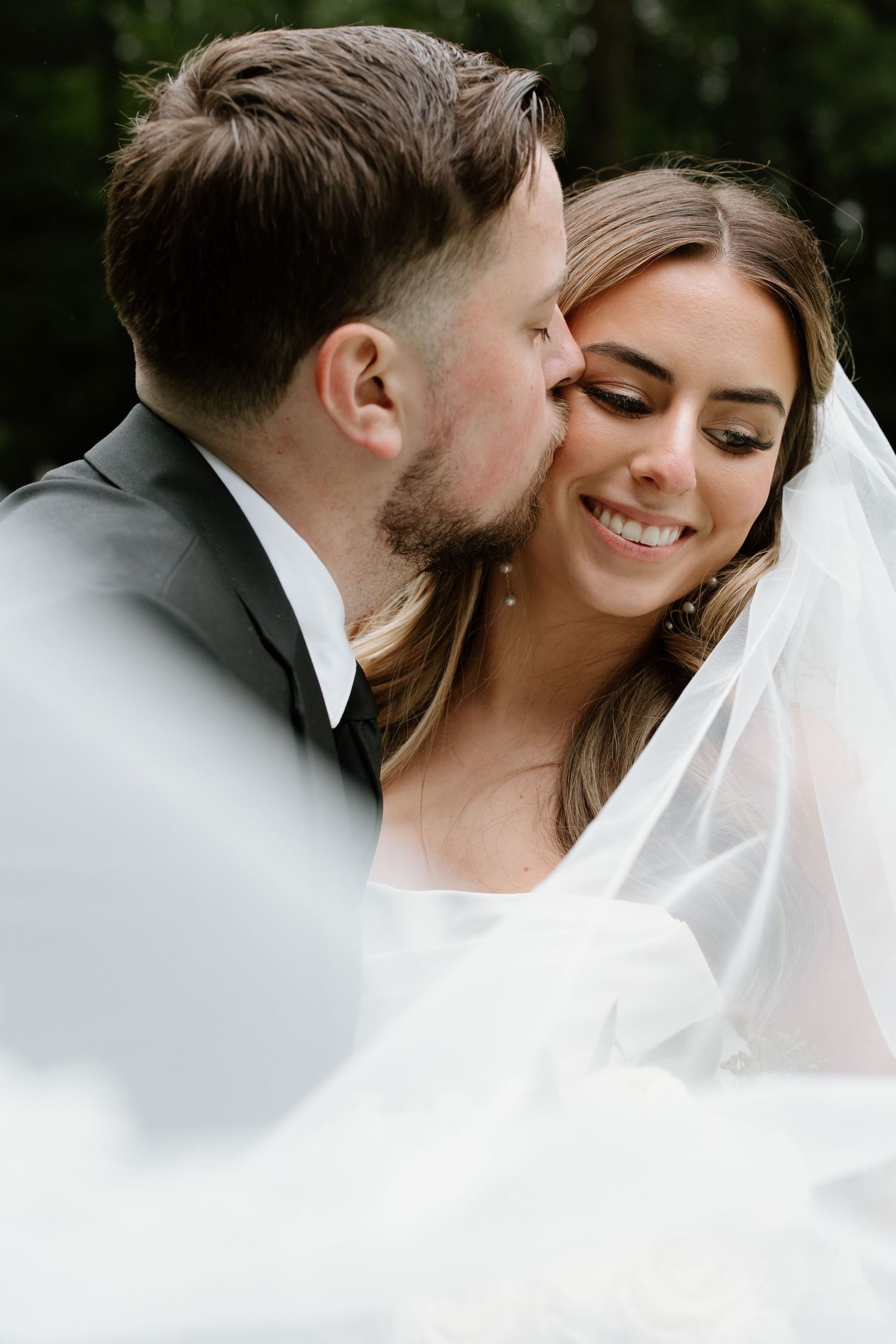 Intimate wedding portrait sequence showing tender moments between newlyweds with flowing veil.