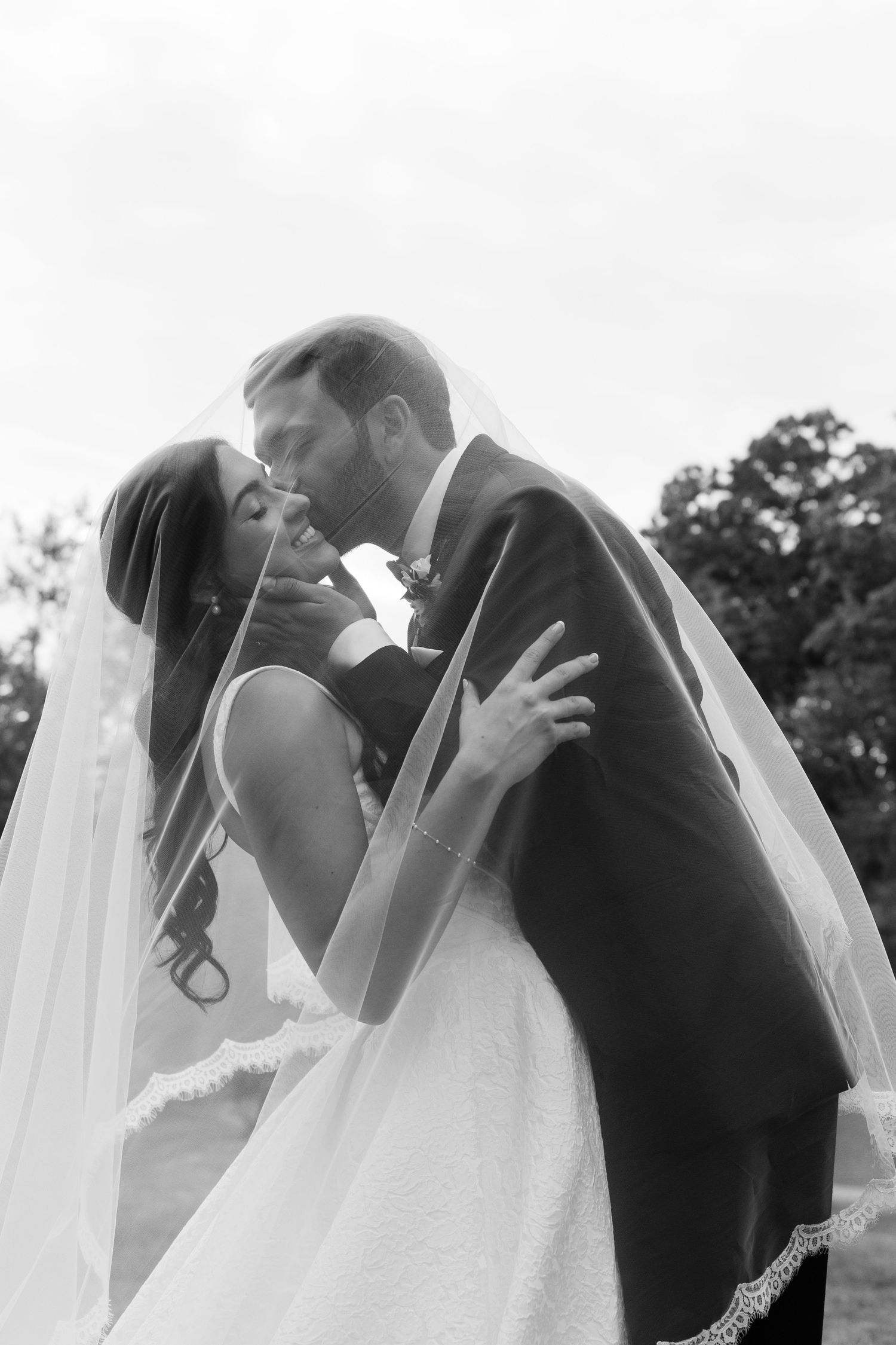 Intimate black and white wedding portraits capture romantic moments between bride and groom.