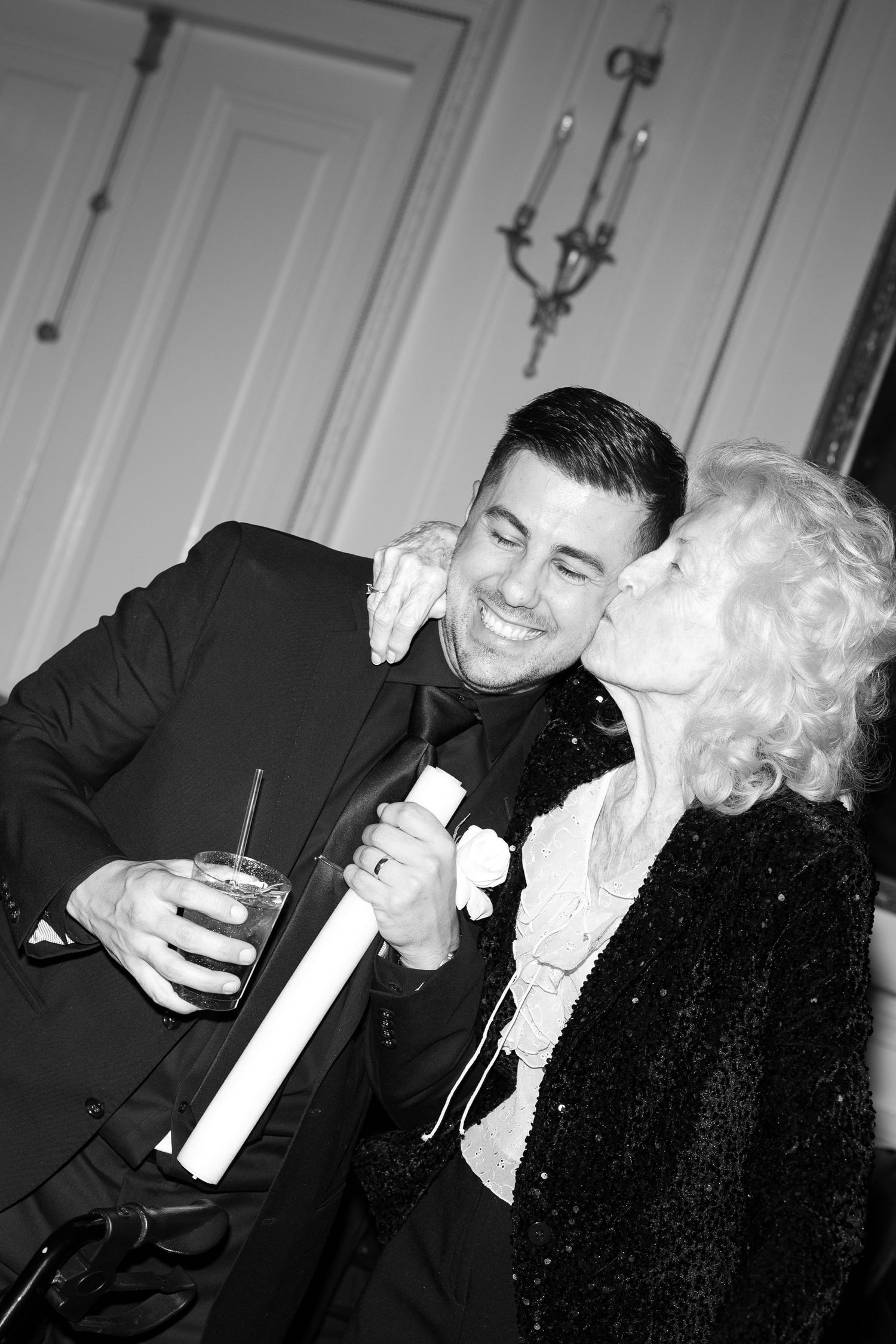 Two people sharing a joyful moment in black and white photography.