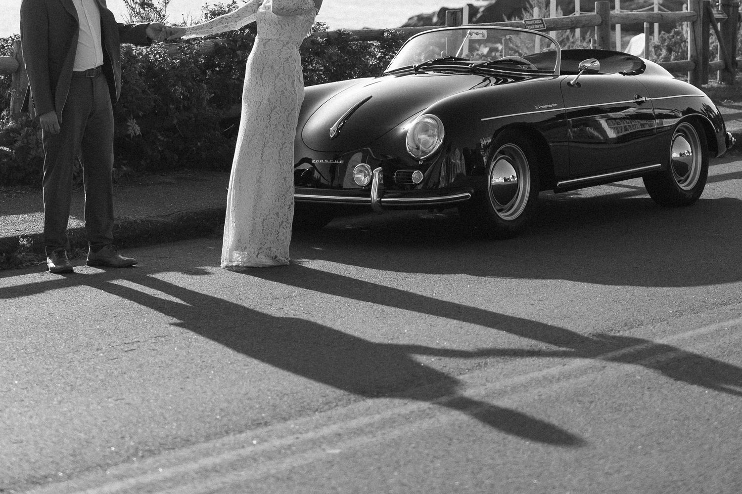 Vintage luxury cars lined up at an outdoor event.