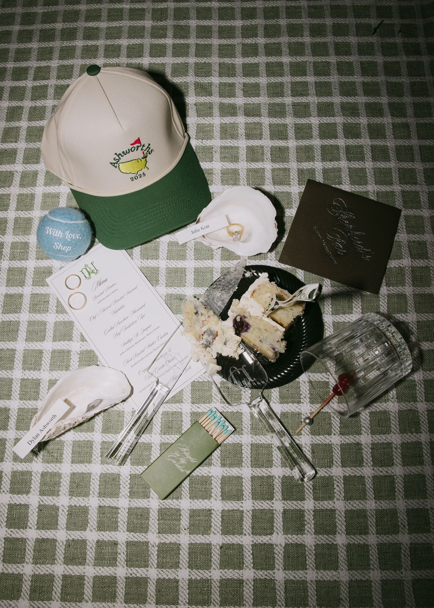 Wedding memorabilia and baseball caps arranged on a checkered surface.