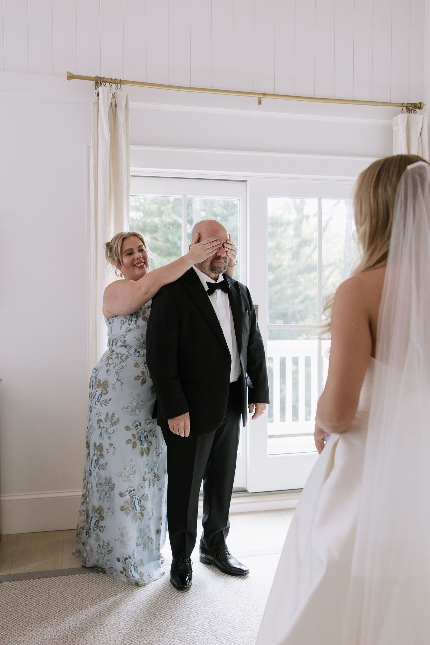 A sweet first look moment before the wedding ceremony in a bright indoor setting.