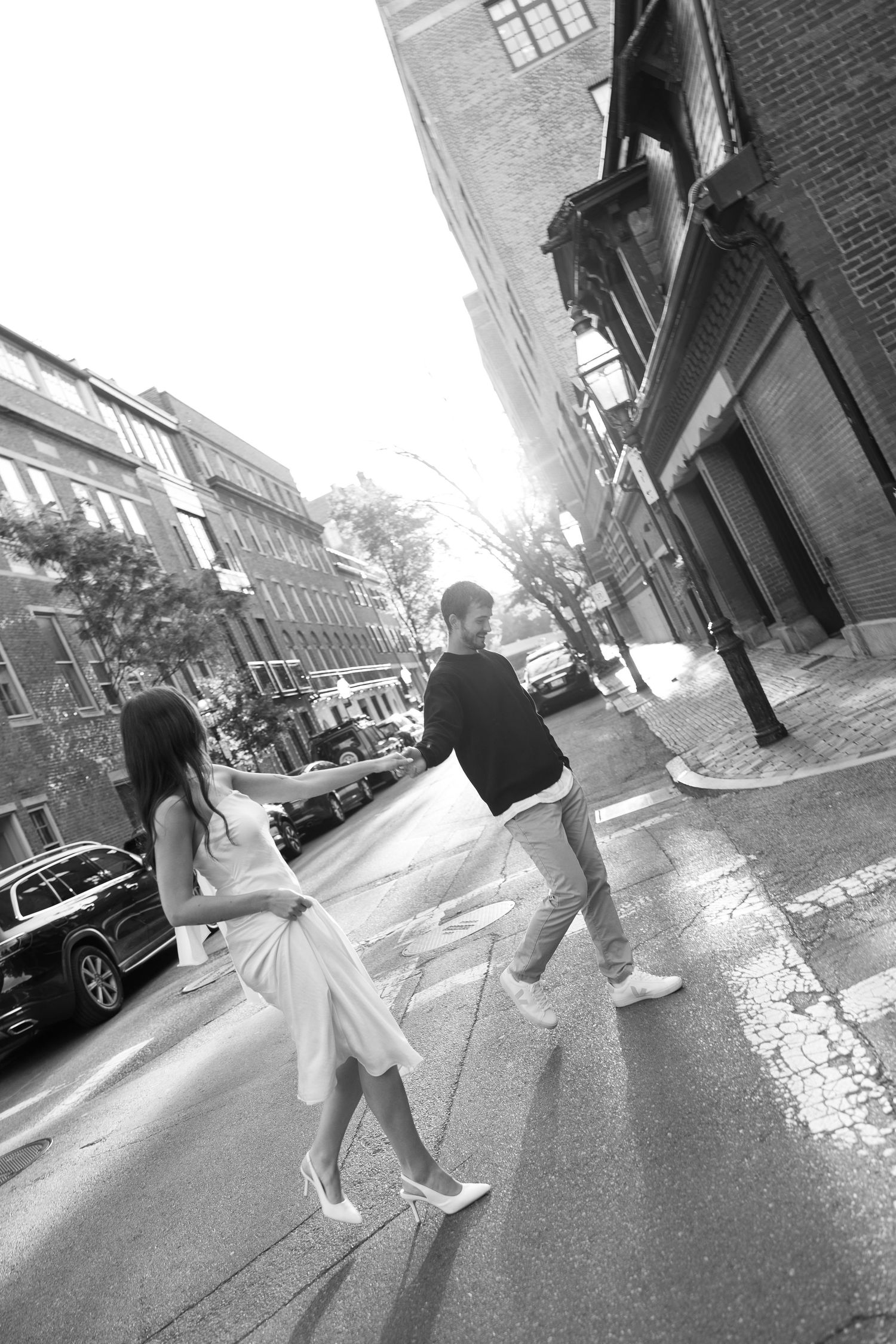 Black and white street photography sequence of two people walking.