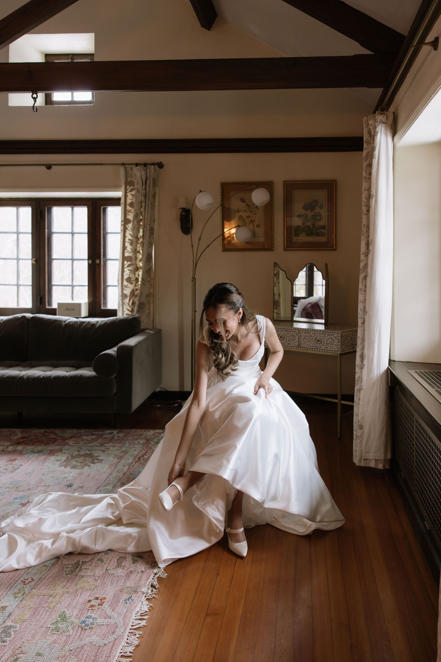 A series of artistic bridal portraits taken on hardwood floors in a room with exposed wooden beams.
