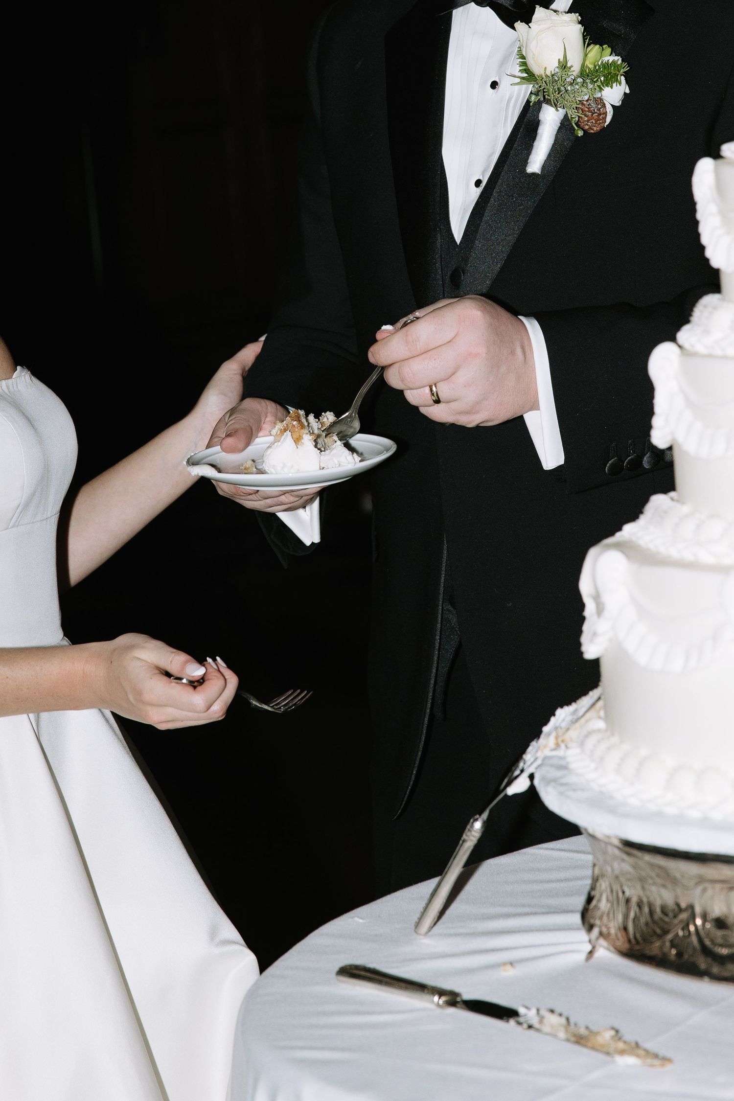 Close-up shots of wedding cake being cut and served at an elegant reception.