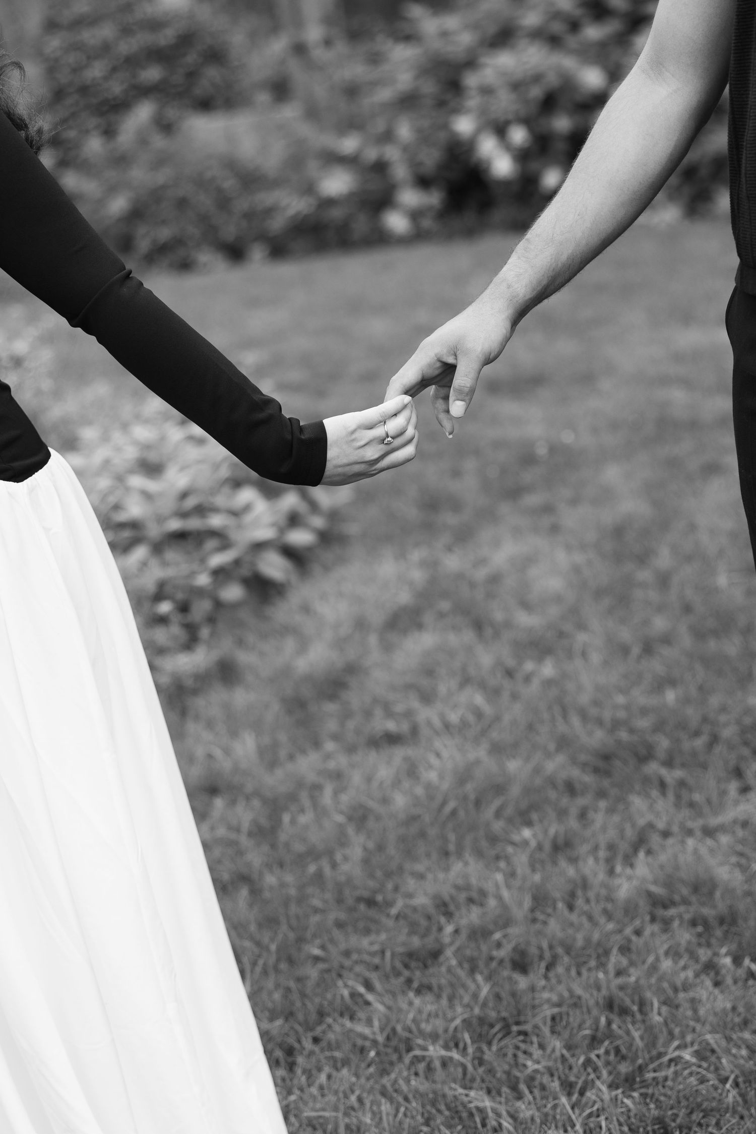 A white dress flows gracefully in the wind against a natural outdoor backdrop.
