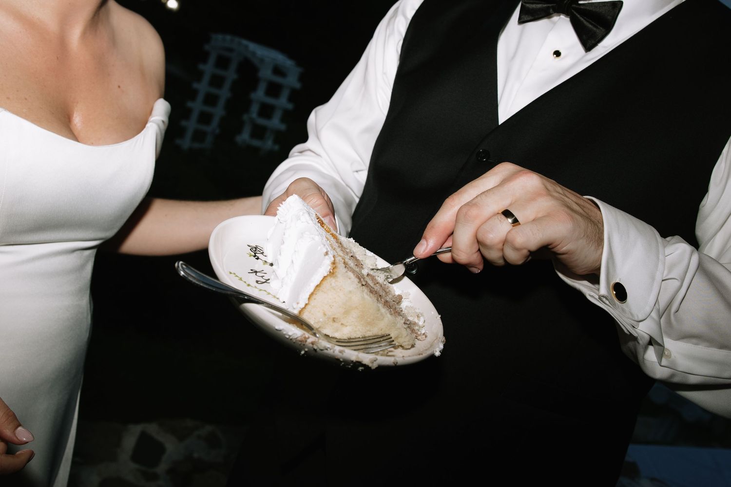 Formal black and white attire details at an elegant event.