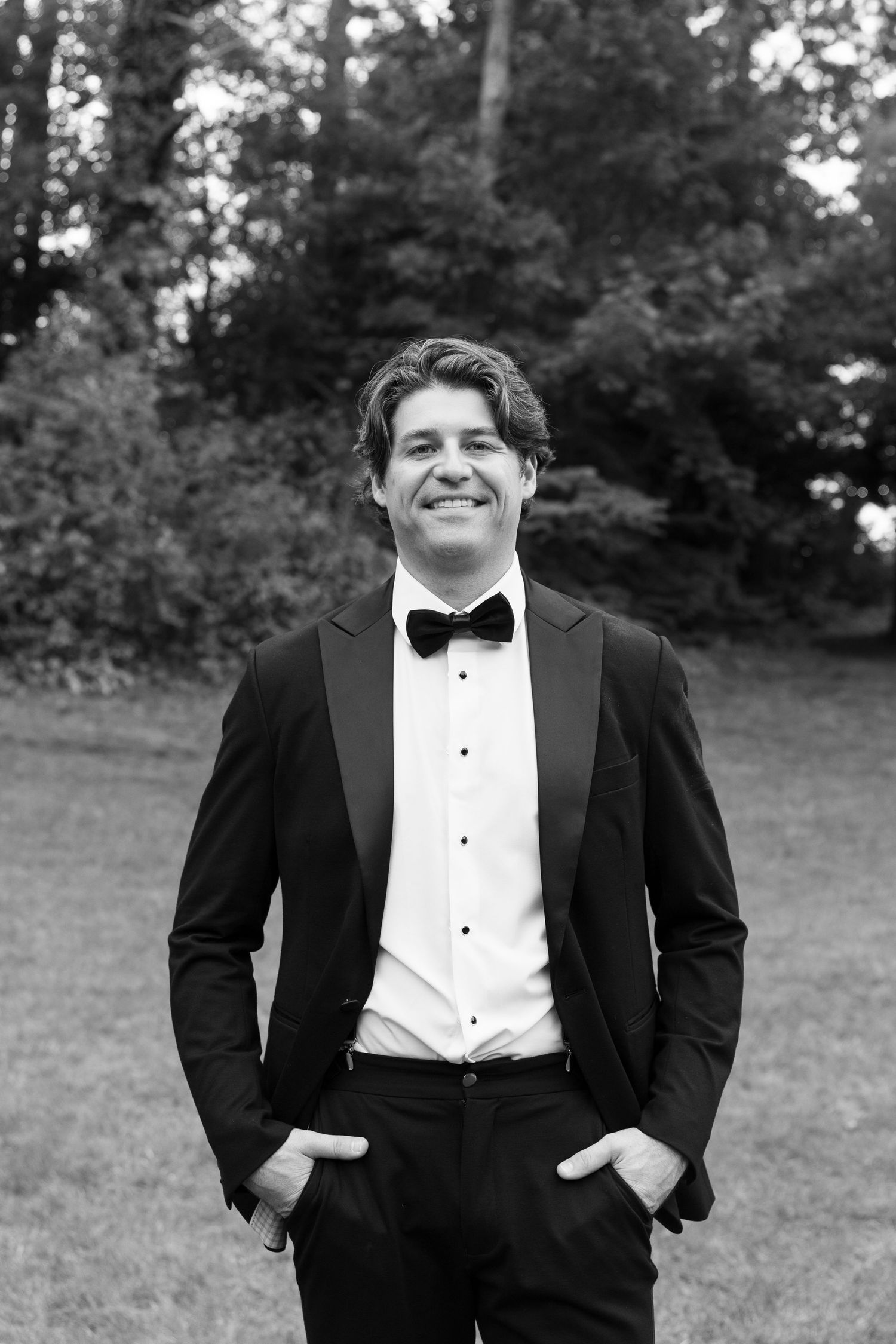 Classic black and white portraits of a groom in a tuxedo and bow tie.