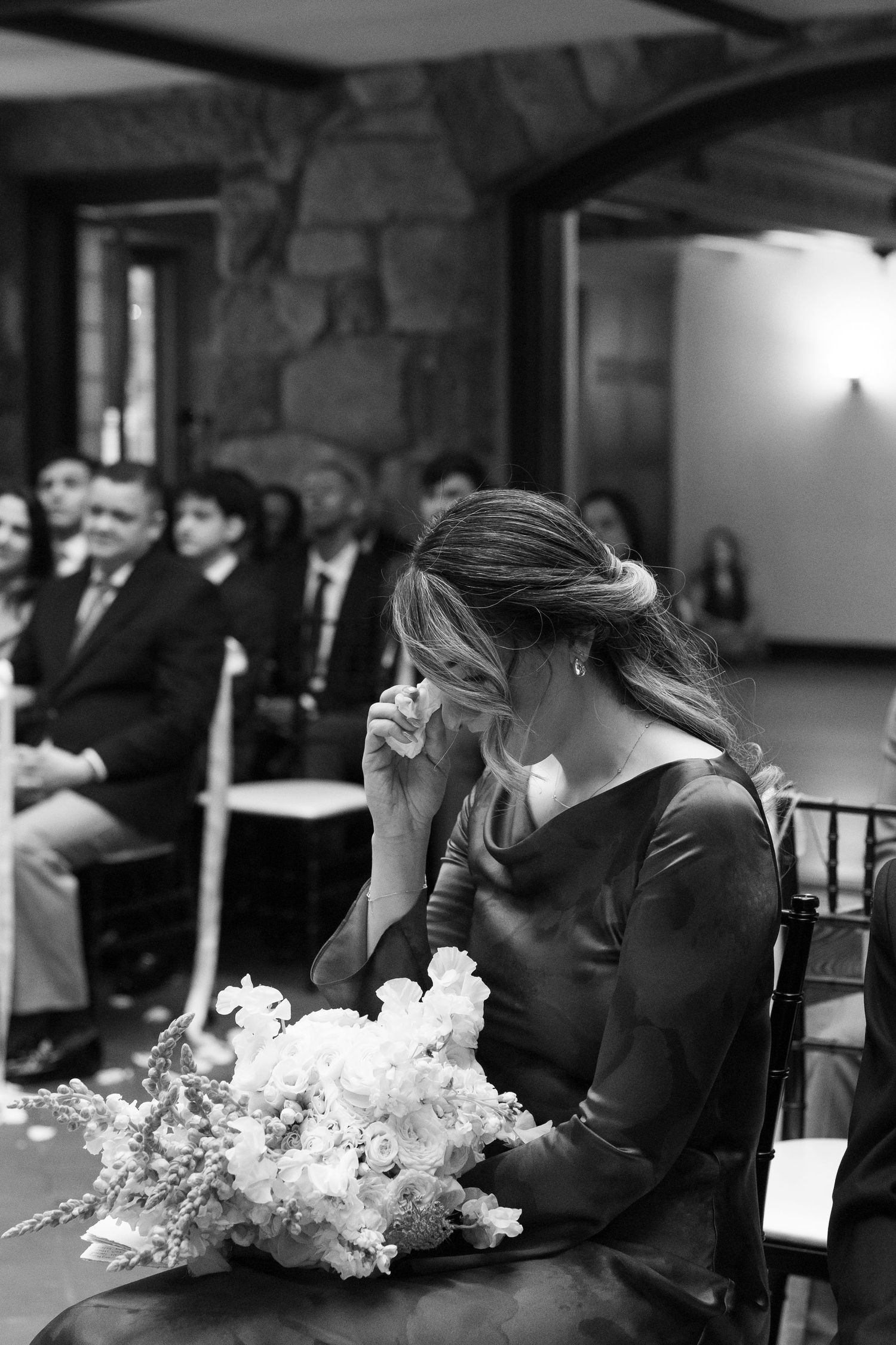 Wedding ceremony candid moments with floral decorations in black and white.