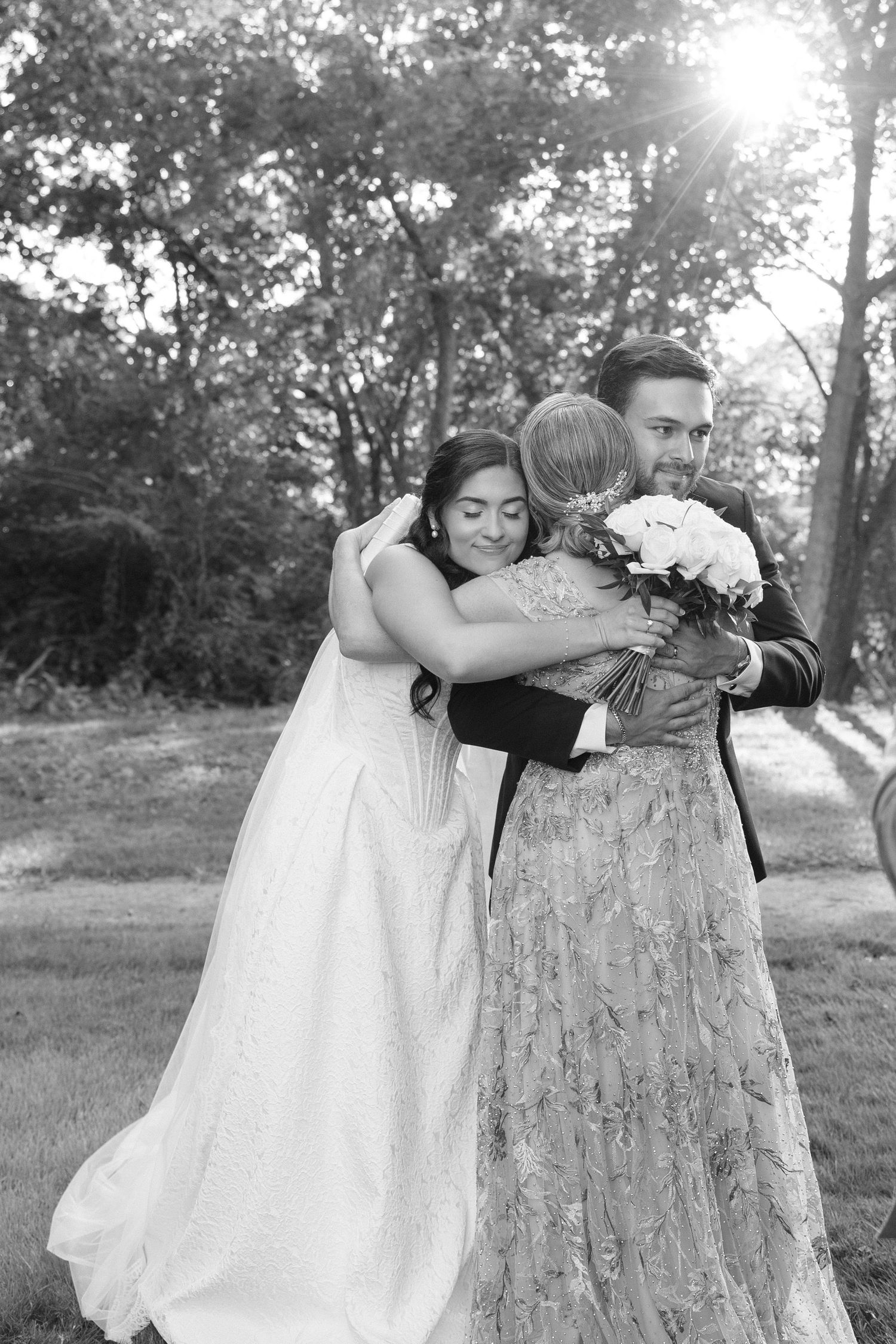 Artistic black and white wedding photography sequence featuring poses with a tree trunk.
