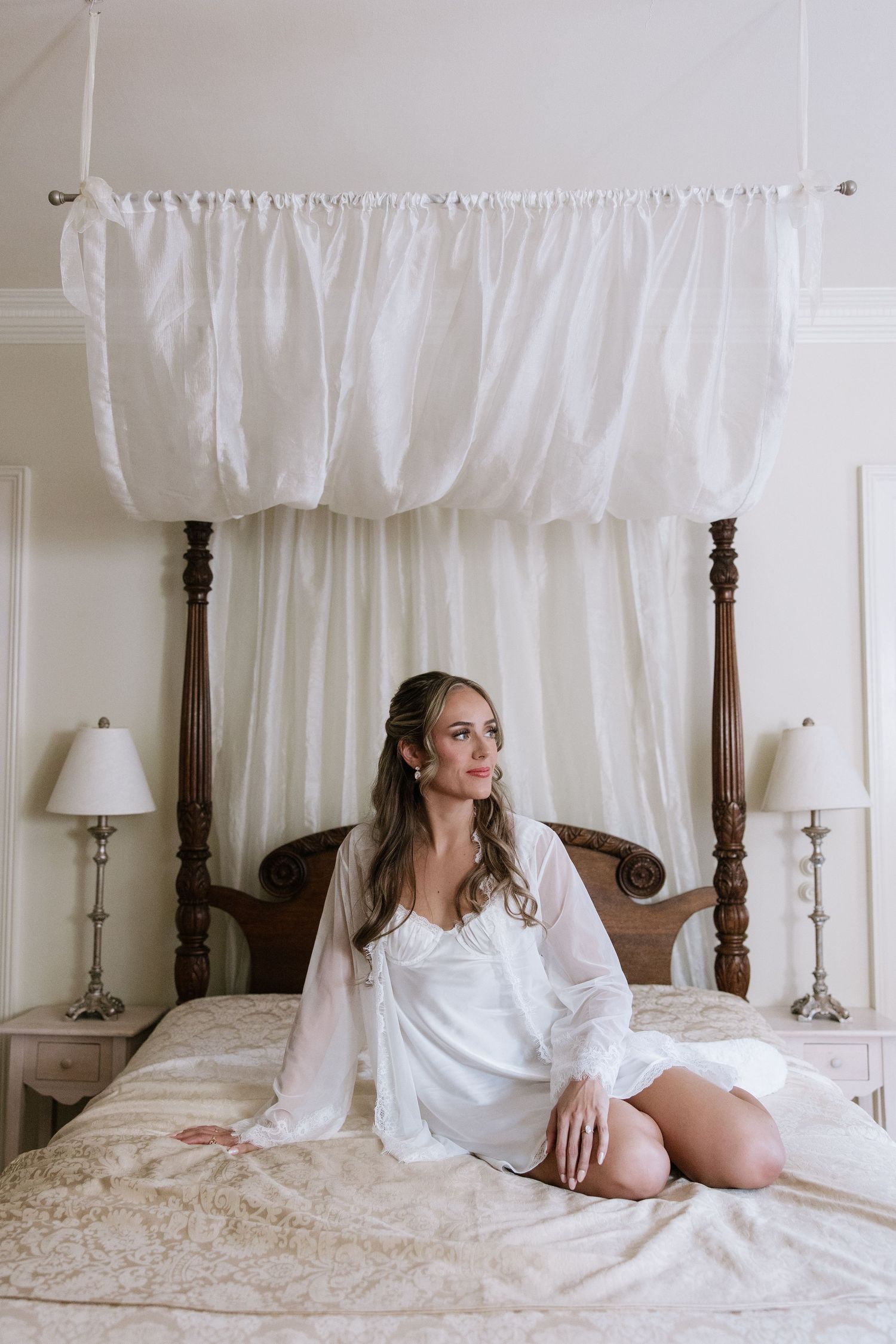Wedding morning preparation scene with white robes and elegant bedroom decor.