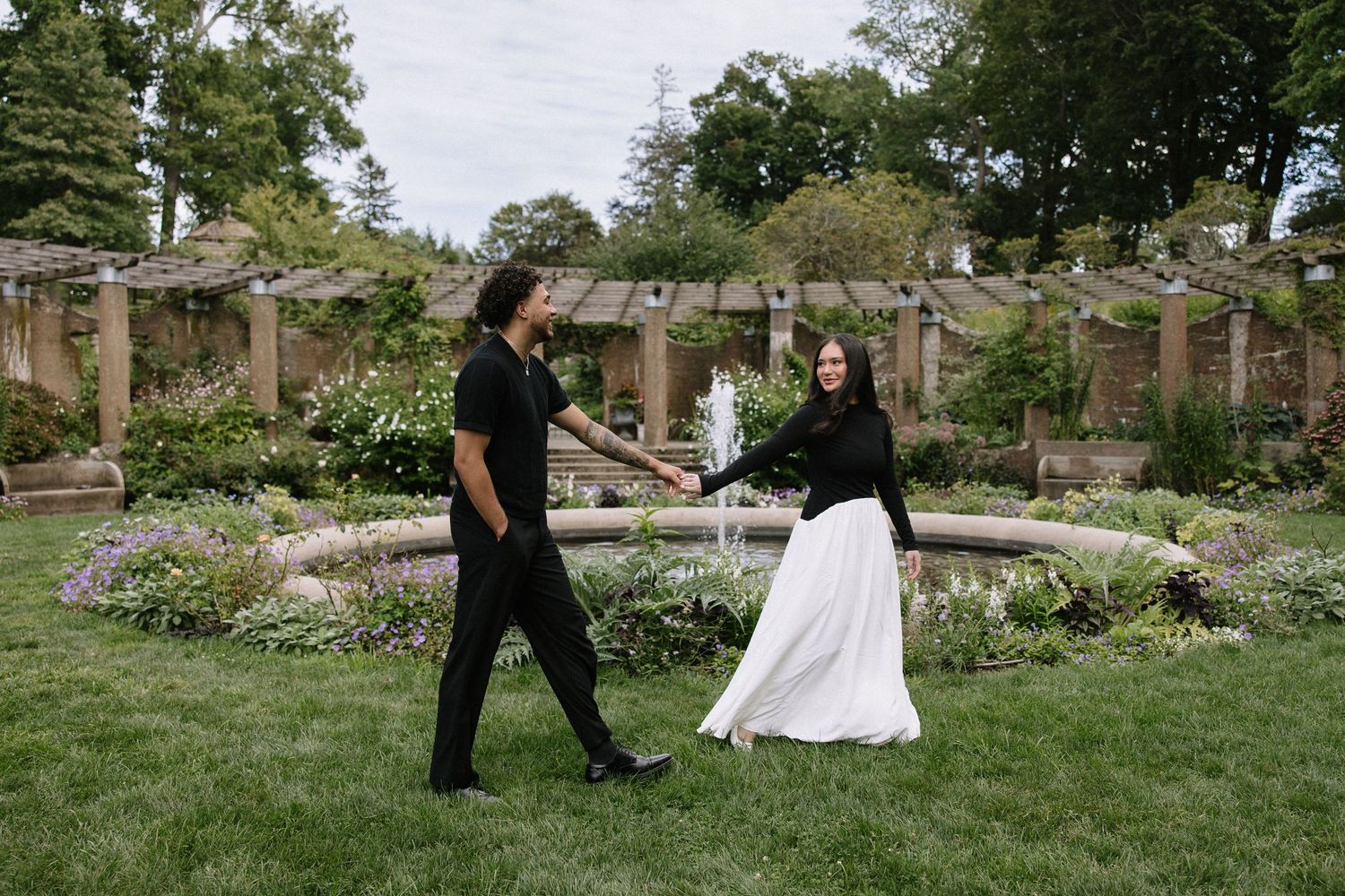 Wedding photography session in a scenic garden with stone architecture.