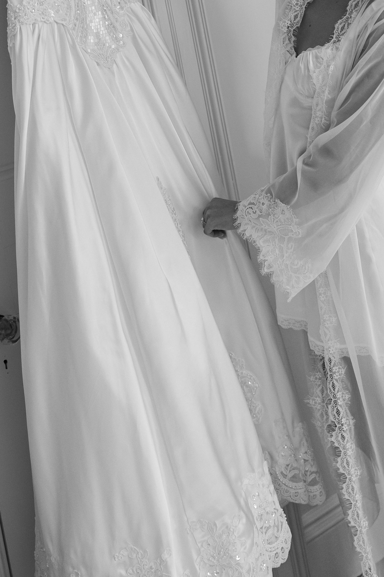 Close-up details of delicate lace and embroidery on white wedding gowns.