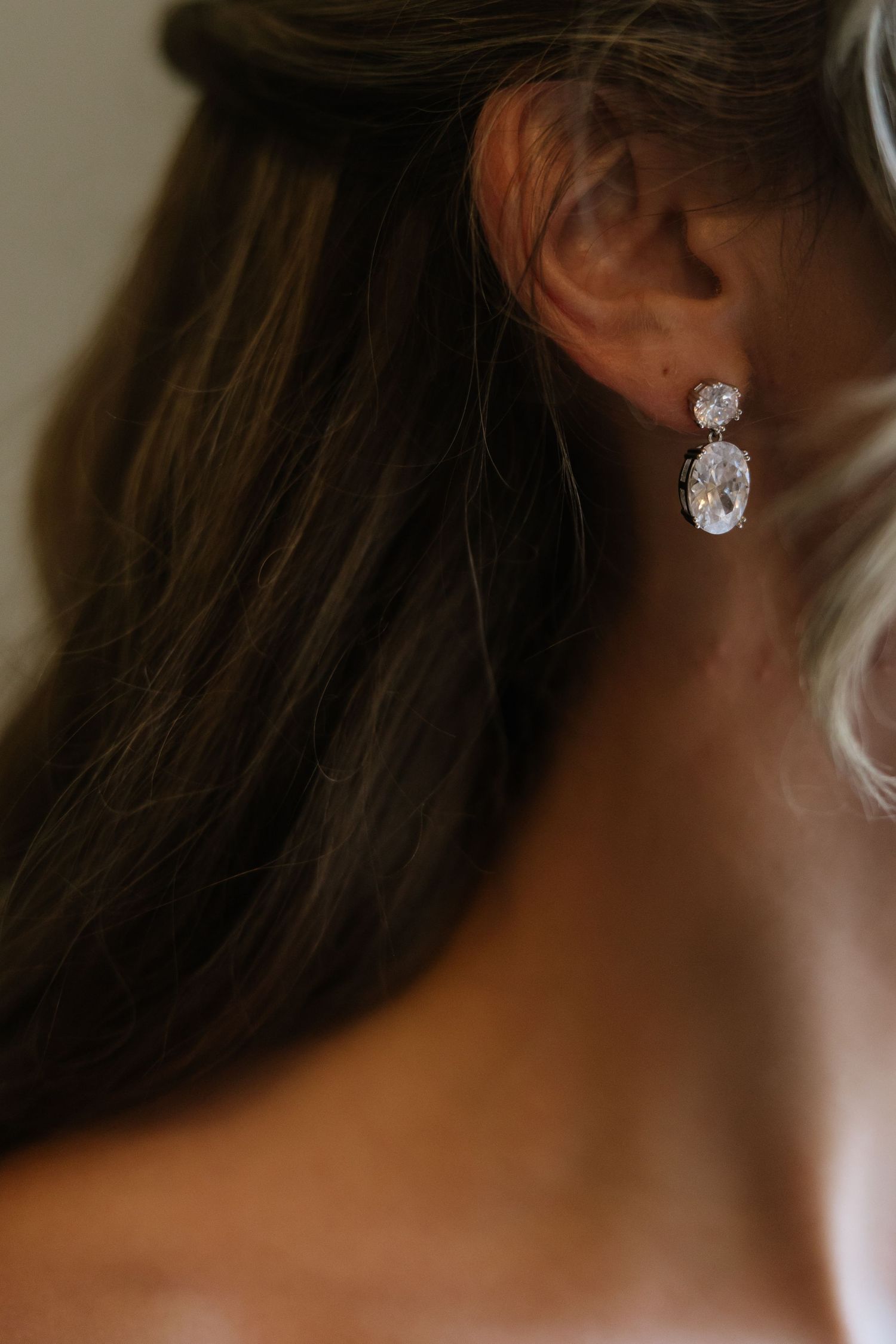 Close-up of sparkling diamond earrings worn on wedding day.