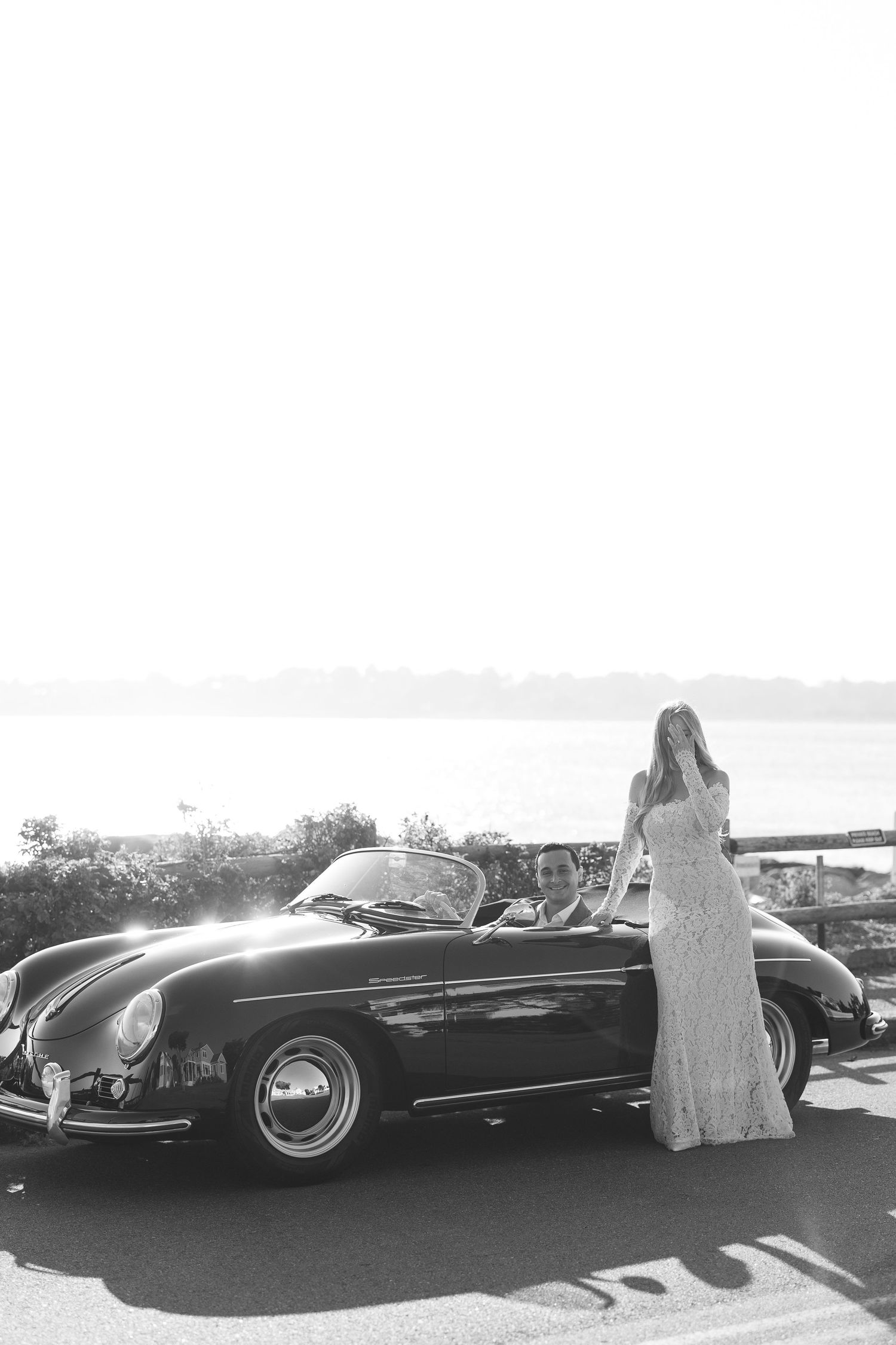 Classic vintage convertibles parked along a scenic coastal overlook.