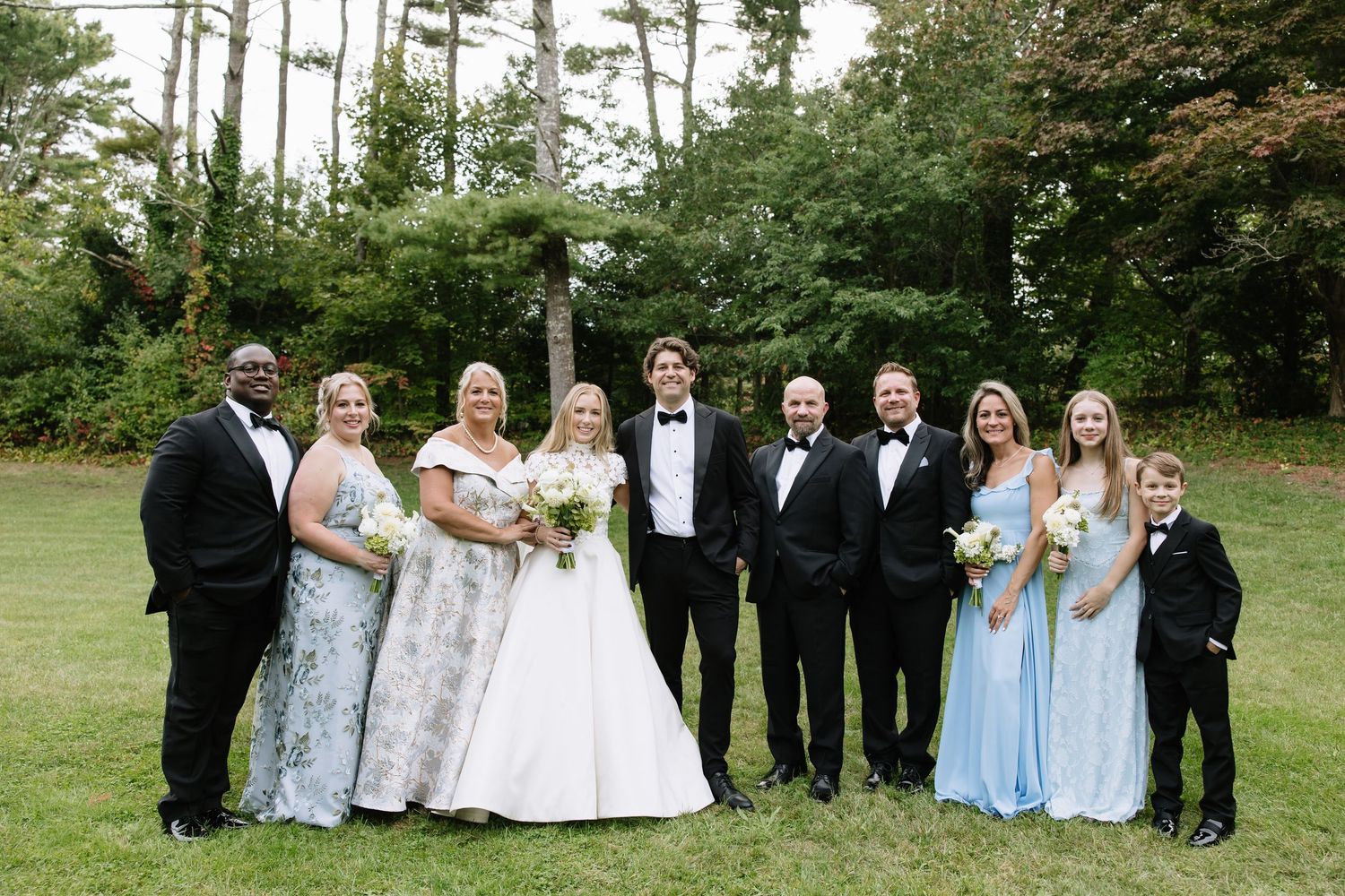 Wedding party group photos with bridesmaids in light blue dresses and groomsmen in black tuxedos outdoors.