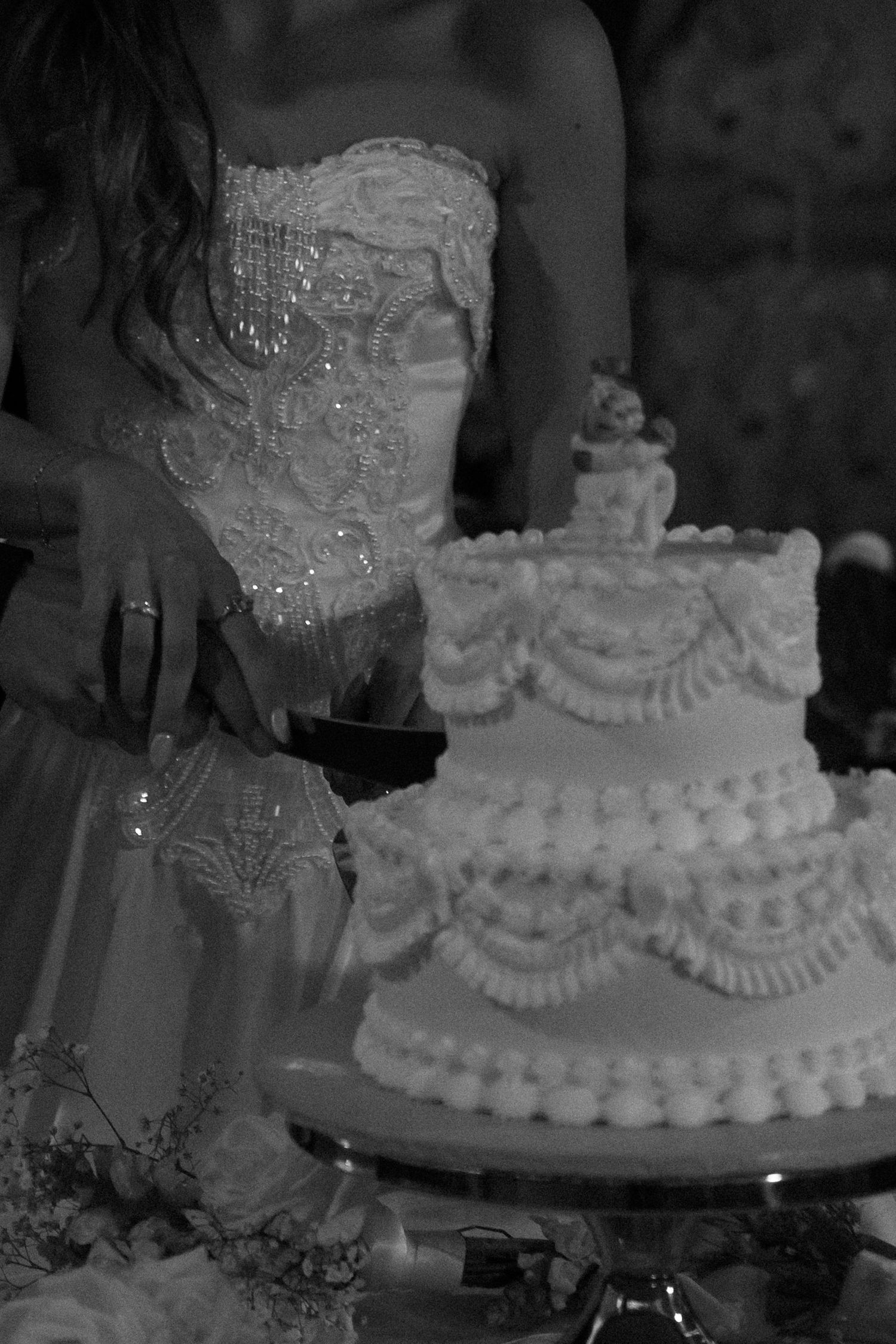 Elegant white wedding cake with traditional piped frosting details.