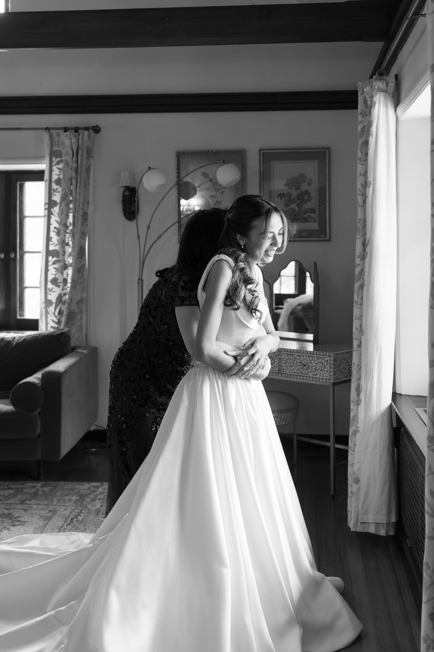 Black and white photos of wedding dress preparations in a sunlit room.