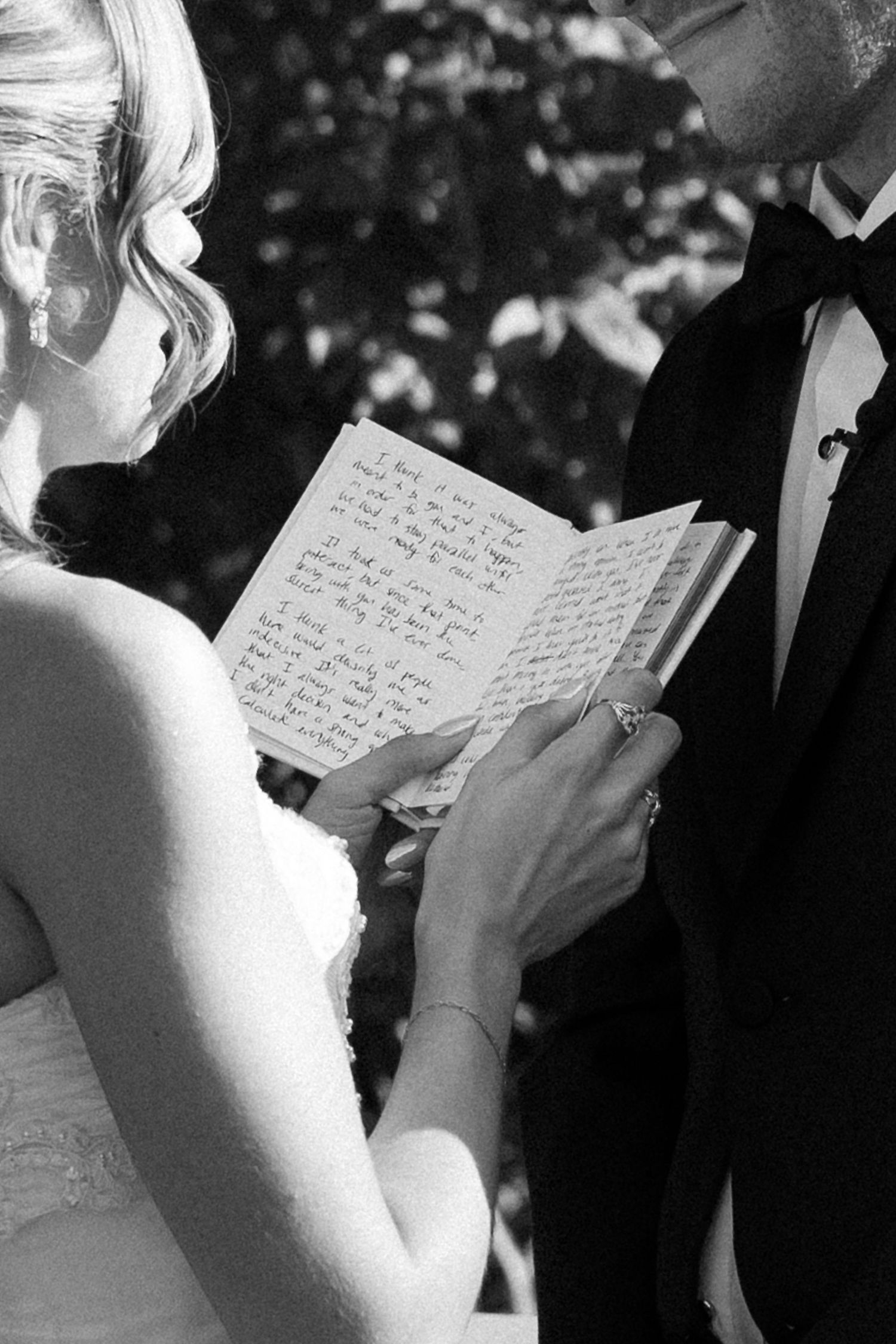 Close-up of handwritten vows being read during a wedding ceremony.