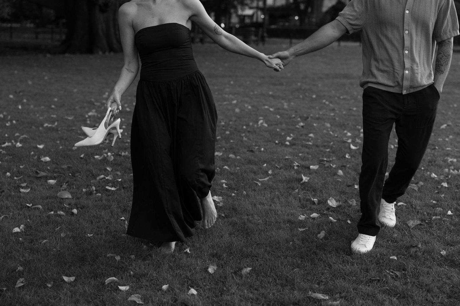 People dancing and moving in silhouette against a dark background outdoors.