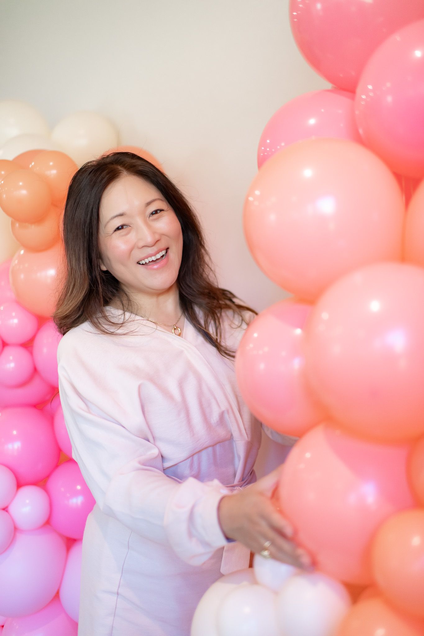 A joyful scene with pink and coral balloon decorations creating a celebratory atmosphere.