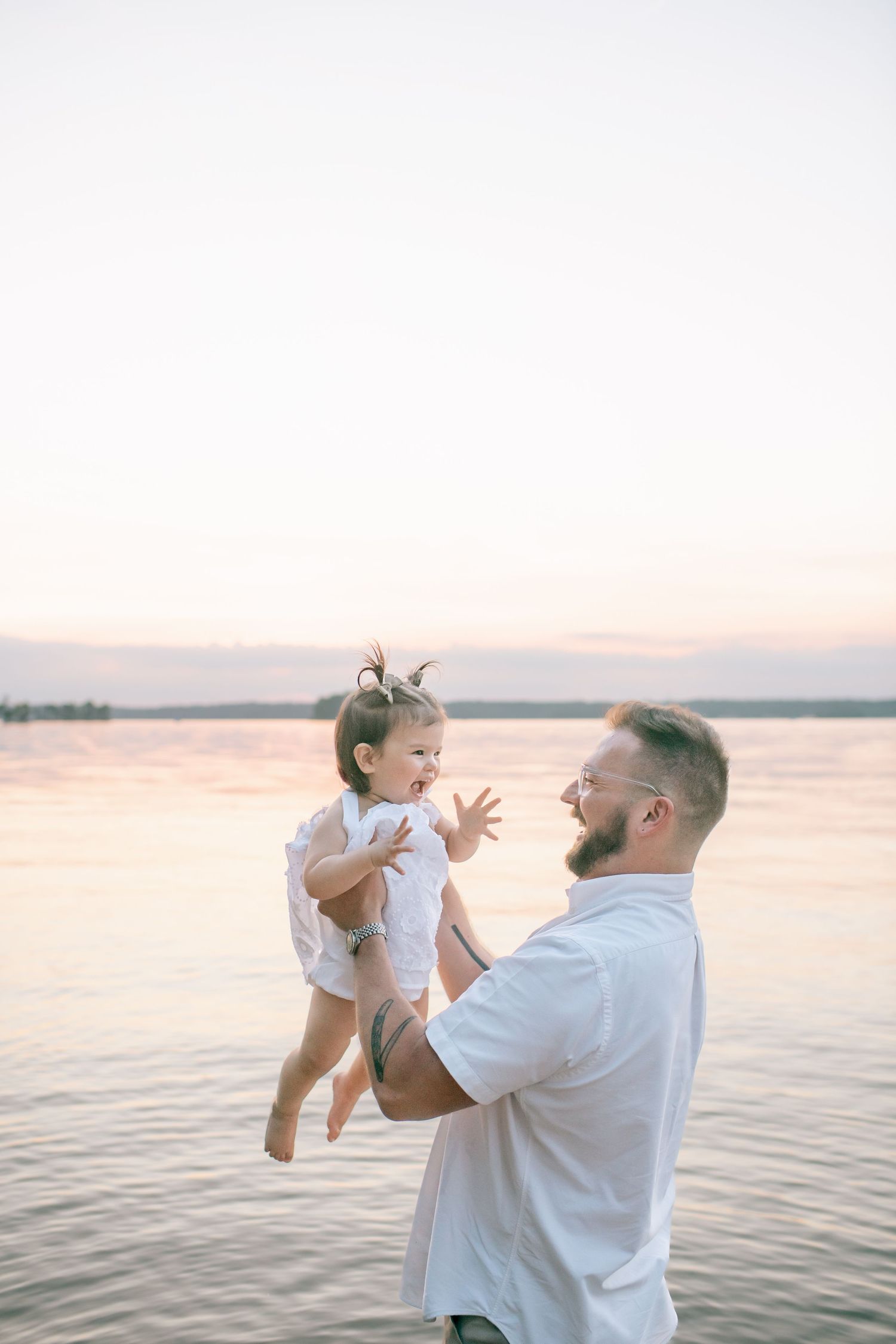 Joyful family moment captured during sunset at the lake.