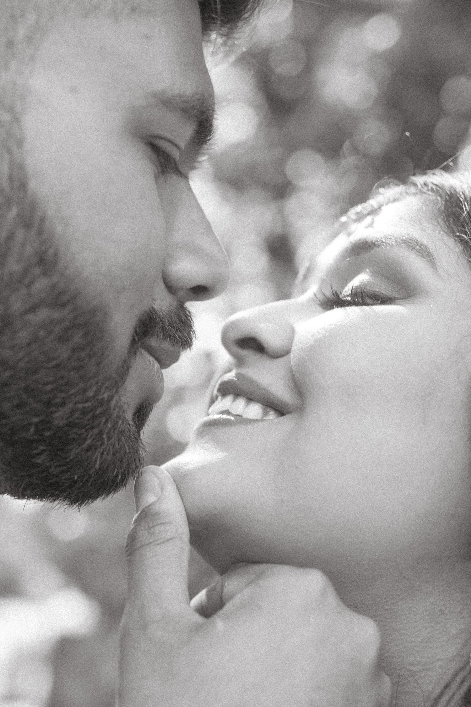 A romantic black and white photo series showing tender intimate moments between a loving couple in soft natural light.