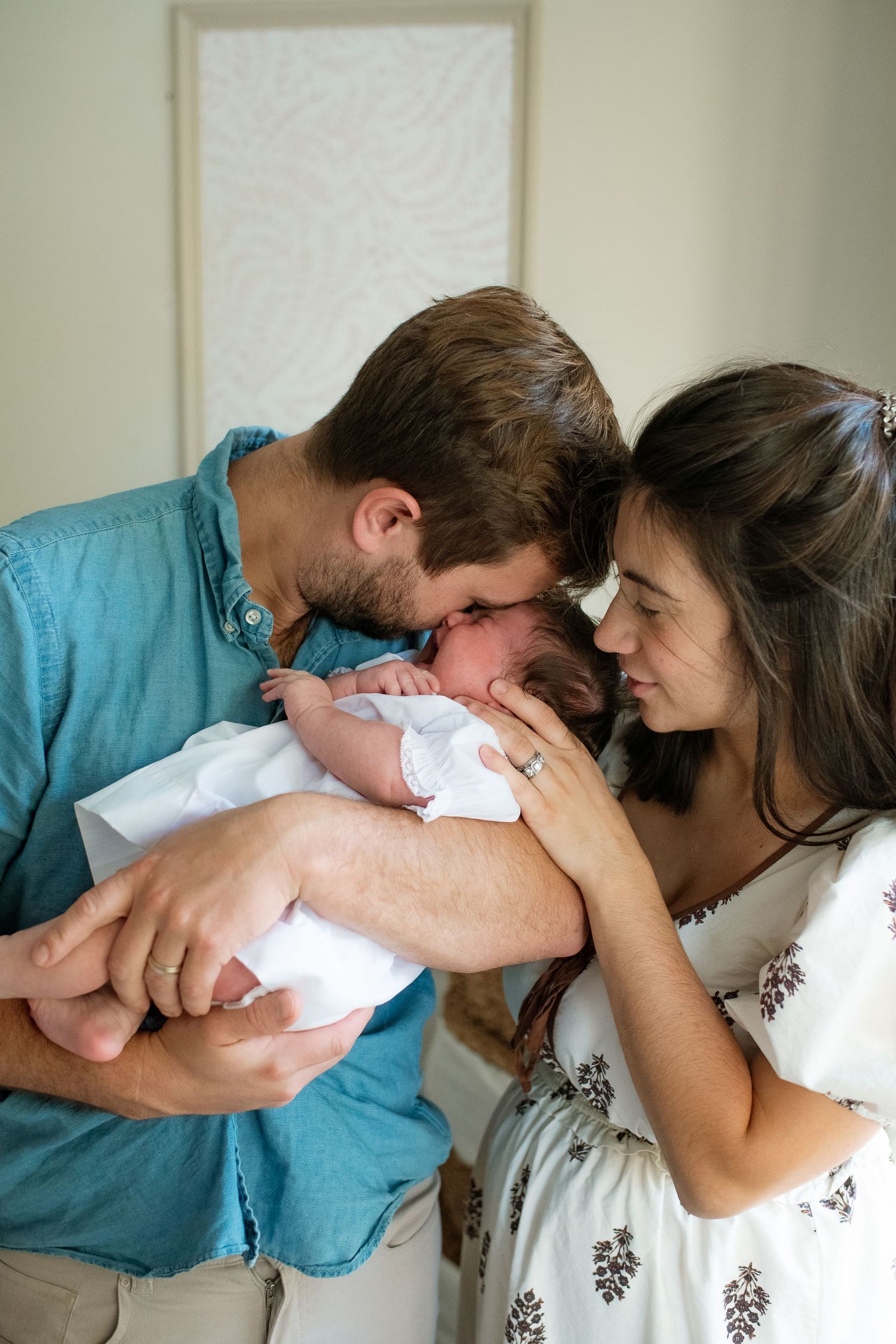 Intimate family moment with a newborn baby captured in a series of loving poses.