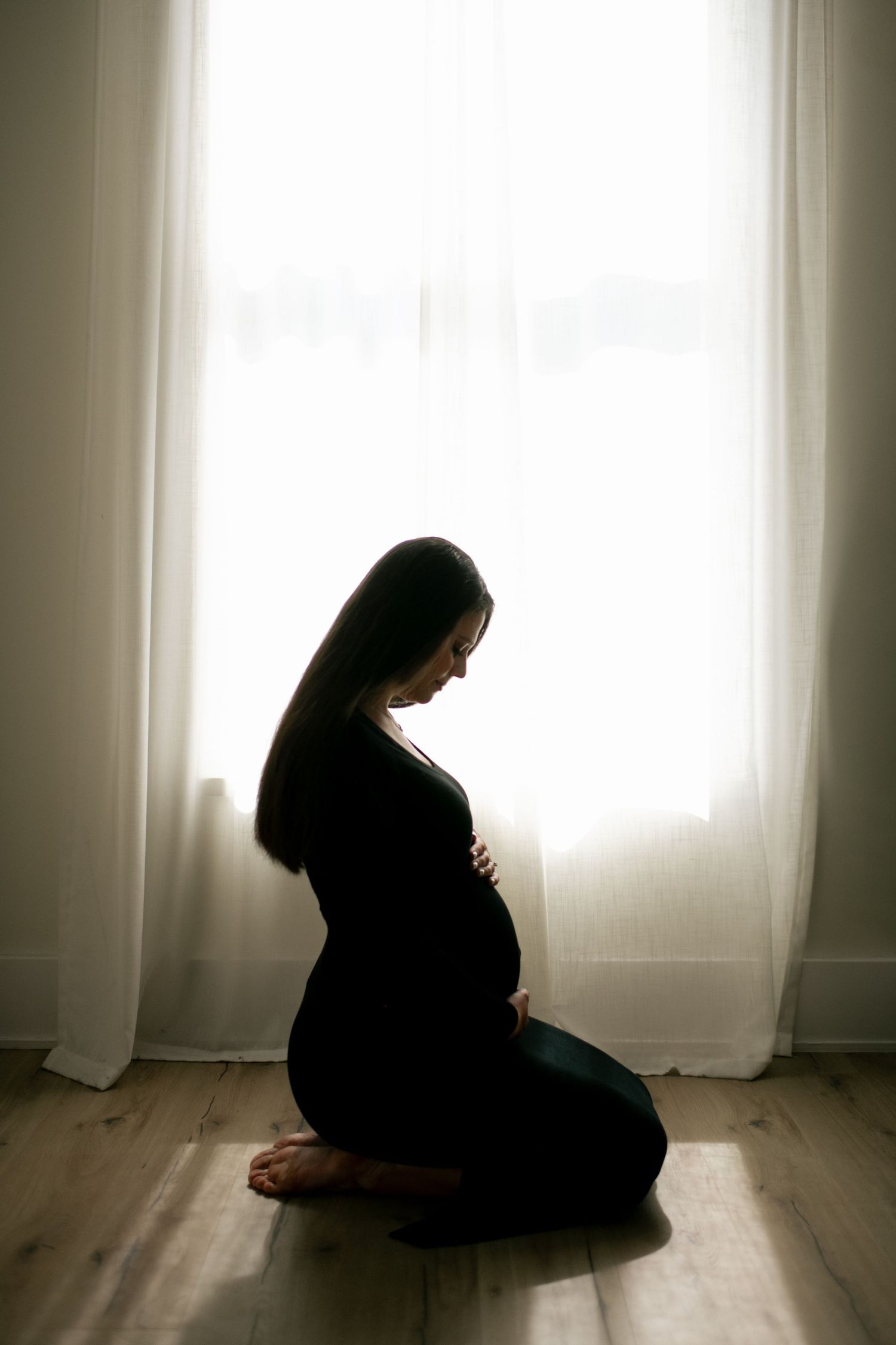 Artistic silhouette series capturing contemplative moments by a bright window.