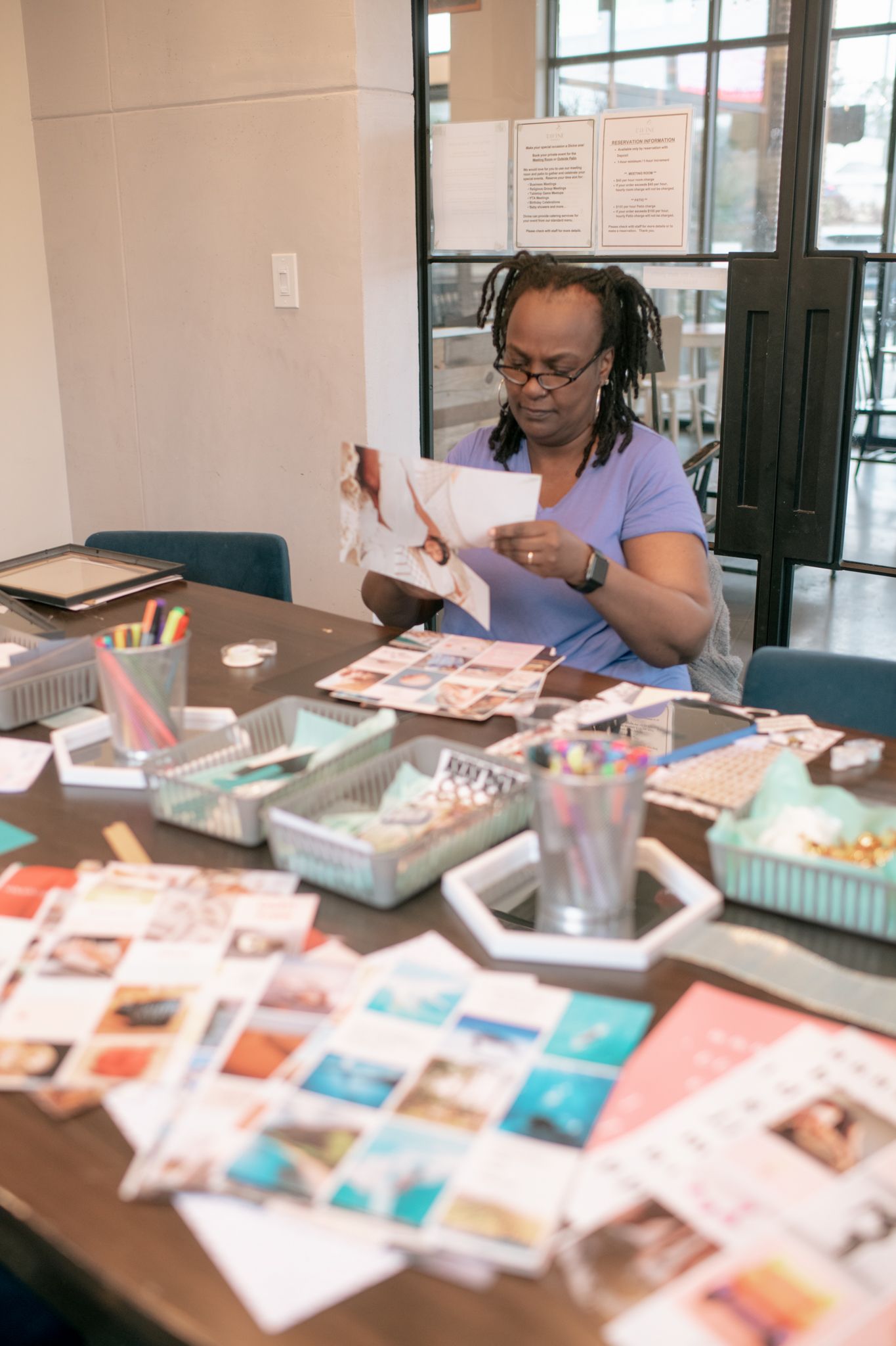 A table covered with colorful cards and creative materials during a workshop session.