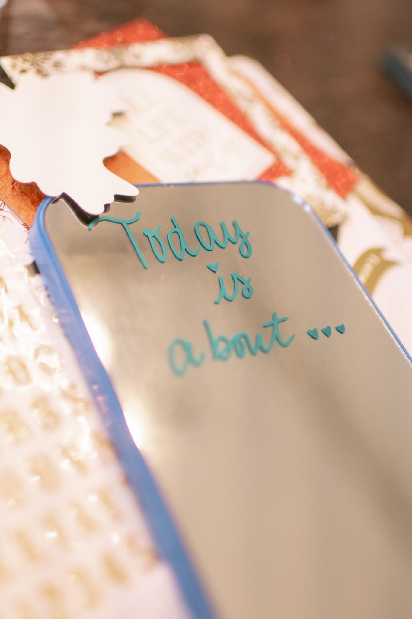 Close-up of handwritten turquoise text on a paper tag that reads 'Today is about...'.