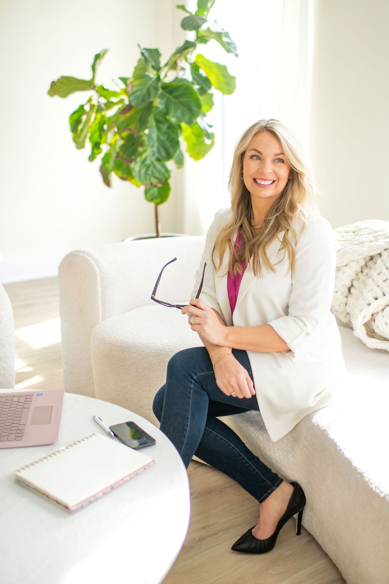 Professional lifestyle photos showing a white couch setting with business casual styling.