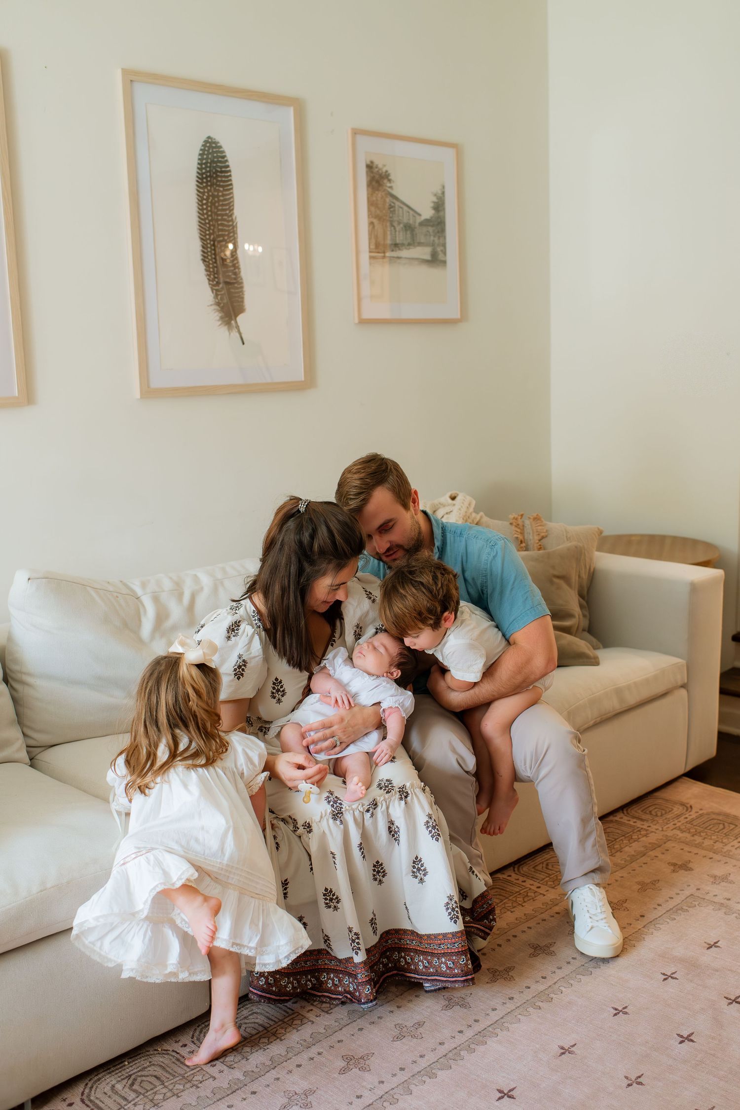 Candid family photos showing joyful interactions on a cream-colored couch with framed art in background.