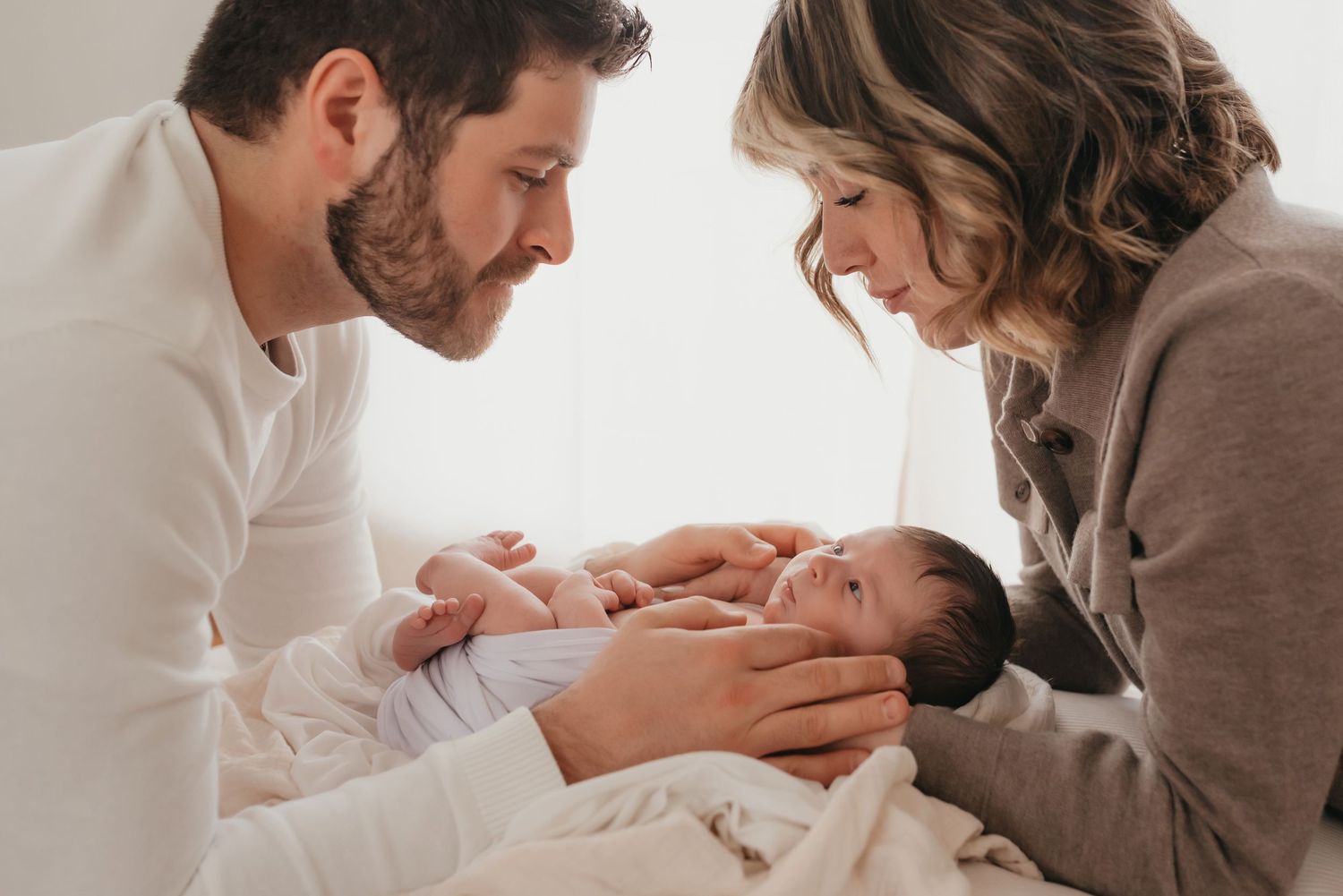 Posed newborn in studio session natural light parent portrait