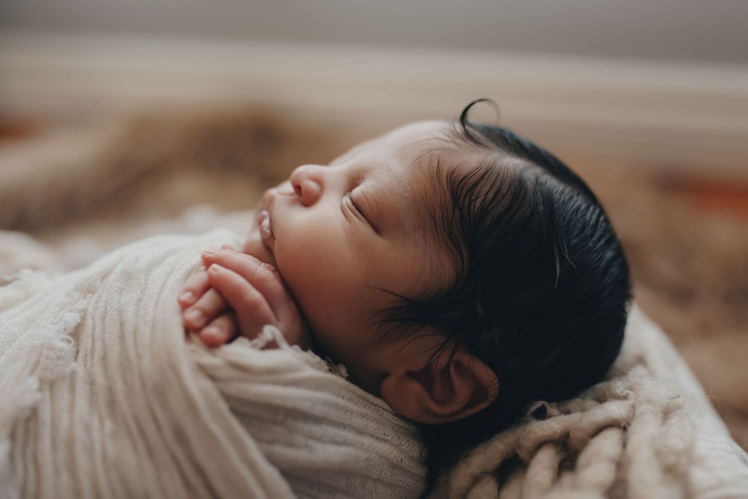 Posed newborn in studio session natural light