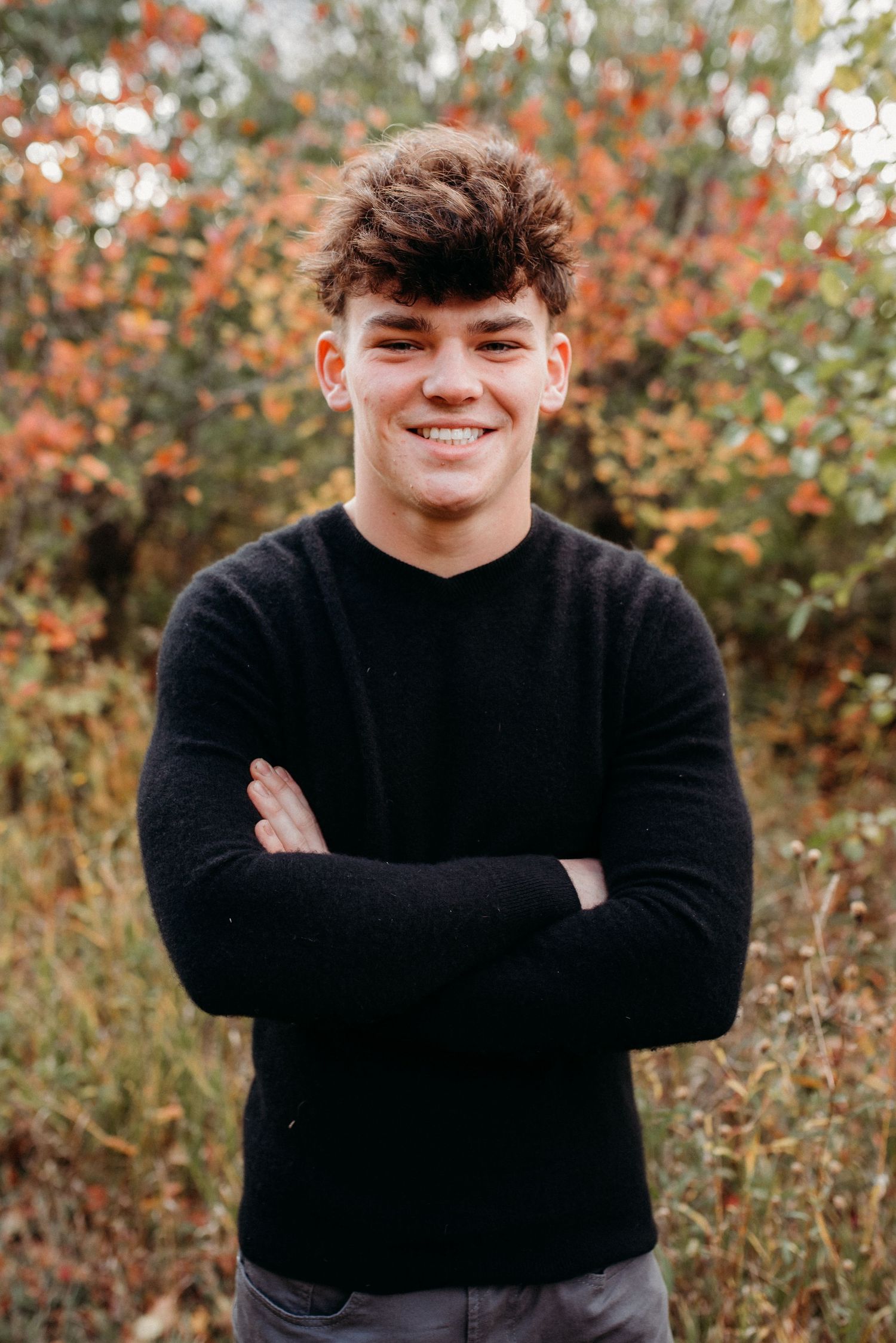 Outdoor headshot in field with trees