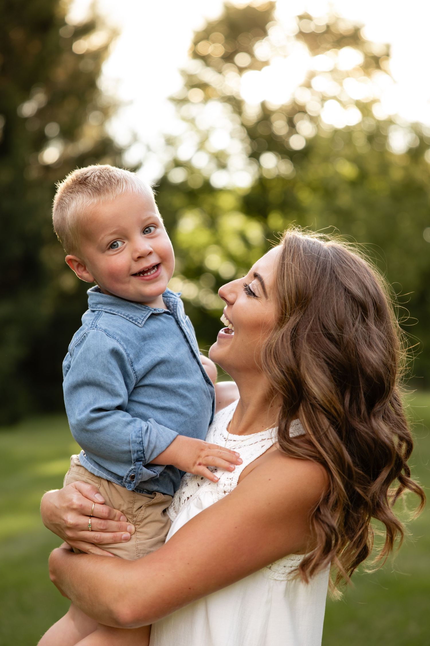Joyful outdoor portrait session in natural setting during golden hour.