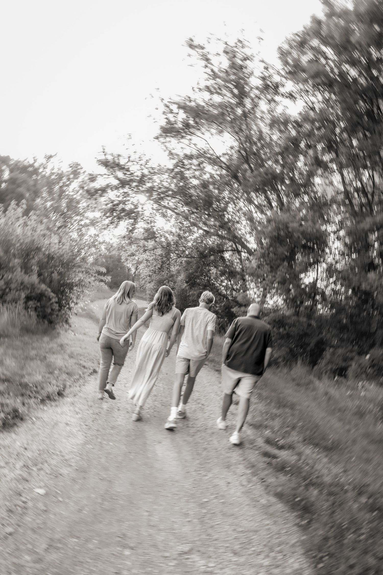 Family walking together on a nature path captured in motion blur.