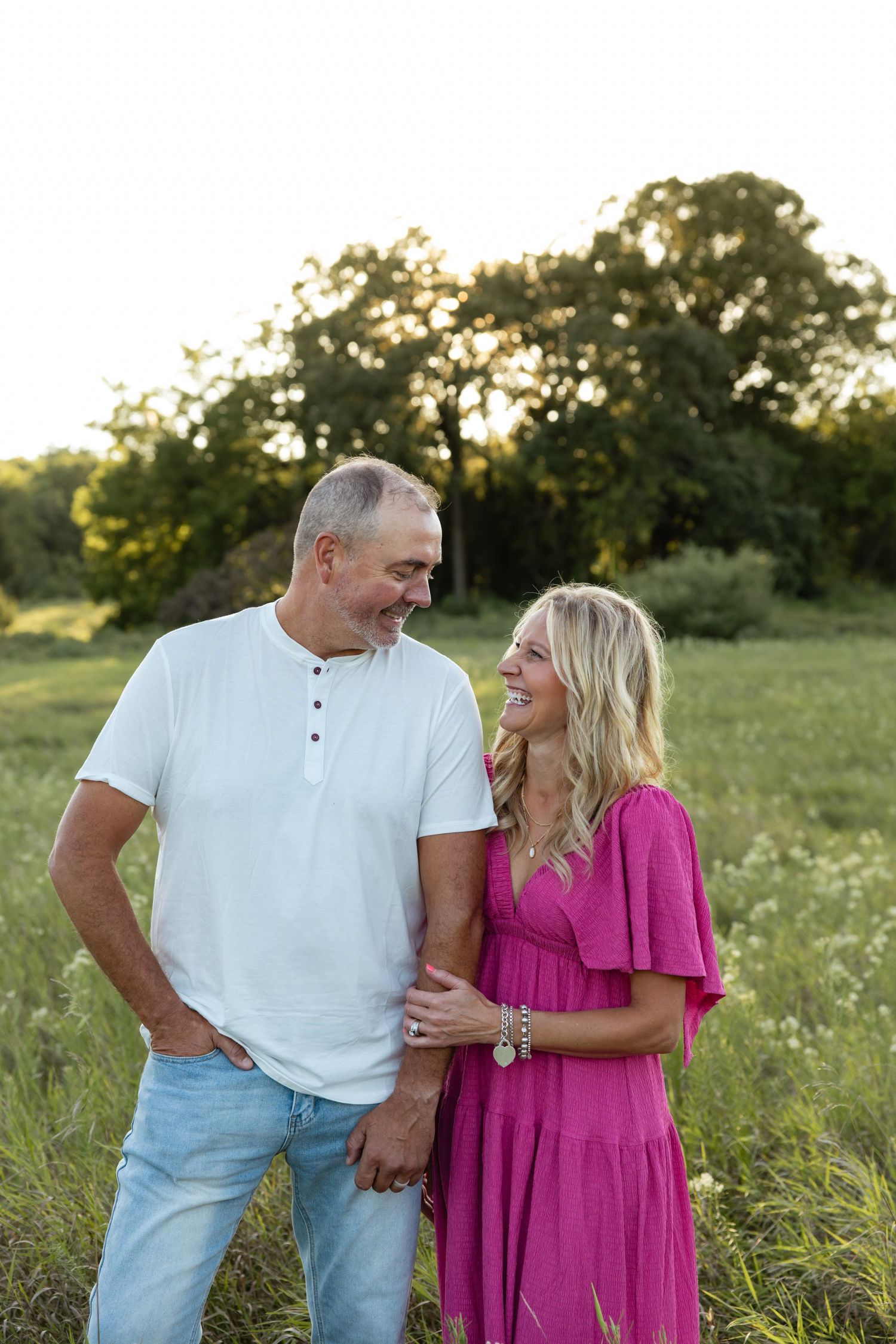 Couple sharing a tender moment in a wildflower field during golden hour.