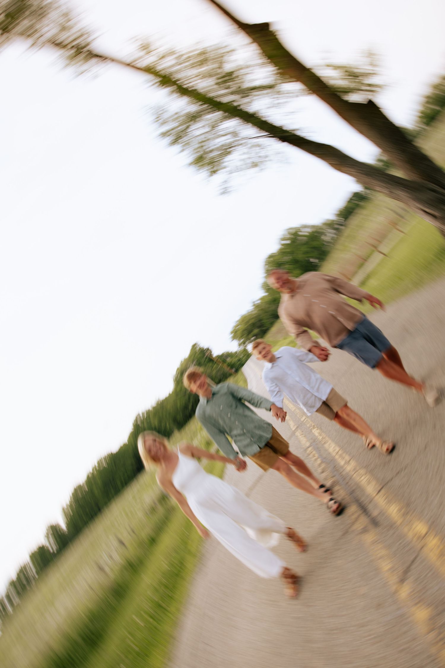 Motion-blurred candid photo of people walking together at sunset.