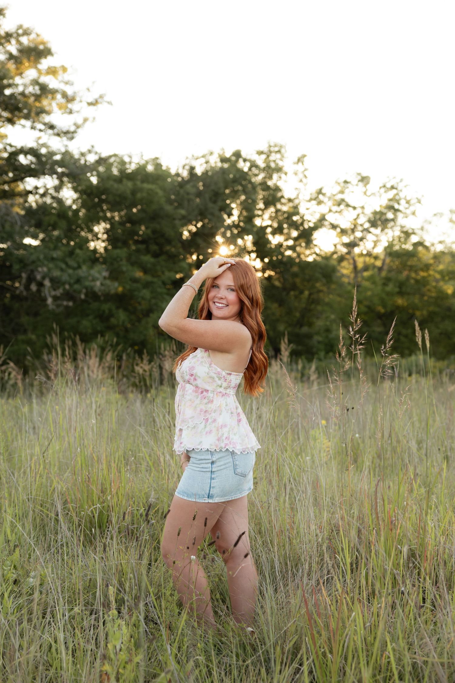 Playful portraits in tall grass field during golden hour.